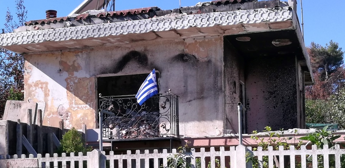 Ύψωσε τη γαλανόλευκη στο καμένο σπίτι της στο Μάτι για την 28η Οκτωβρίου!