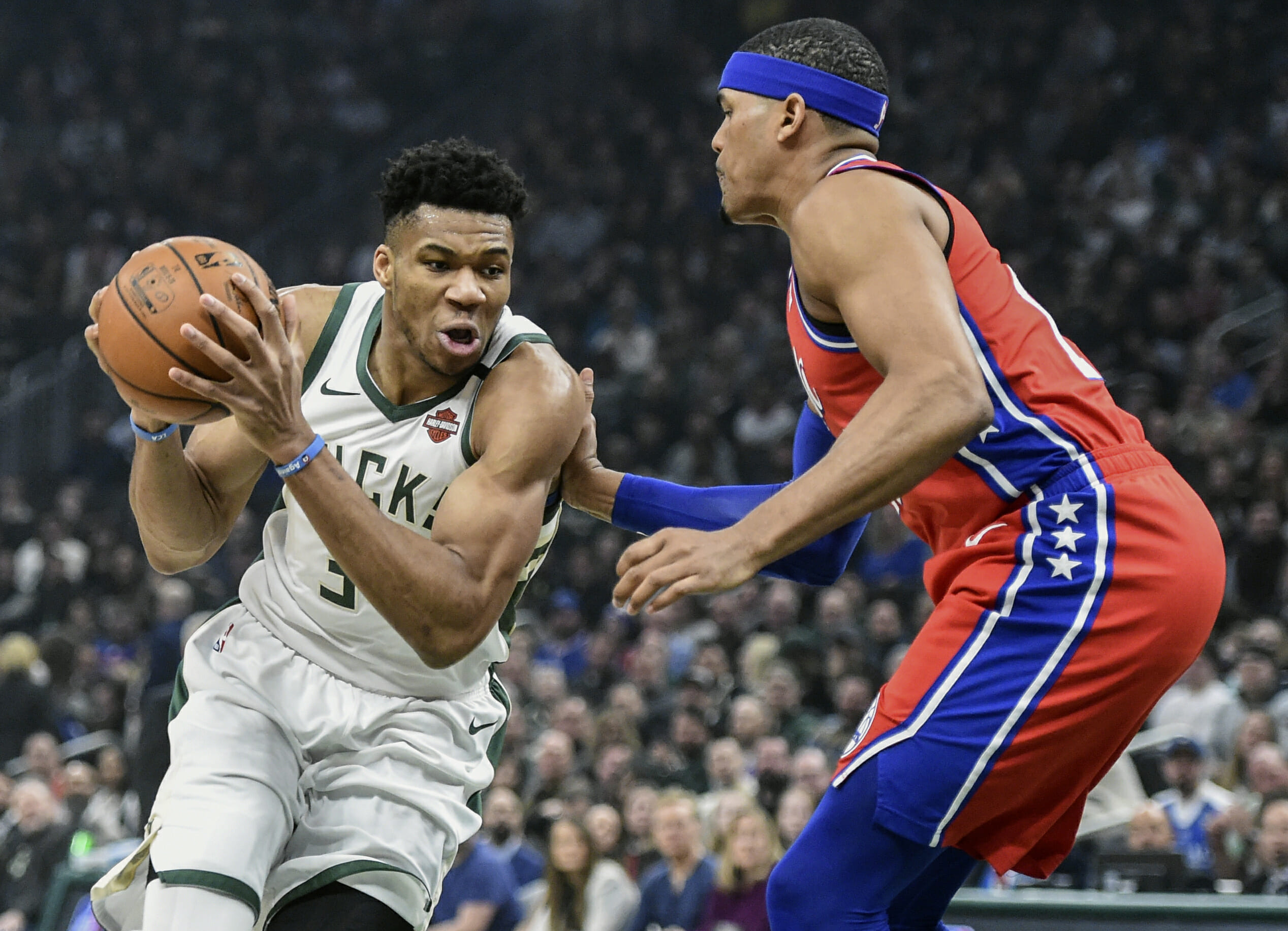 Feb 22, 2020; Milwaukee, Wisconsin, USA;  Milwaukee Bucks forward Giannis Antetokounmpo (34) drives for the basket against Philadelphia 76ers forward Tobias Harris (12) in the first quarter at Fiserv Forum. Mandatory Credit: Benny Sieu-USA TODAY Sports