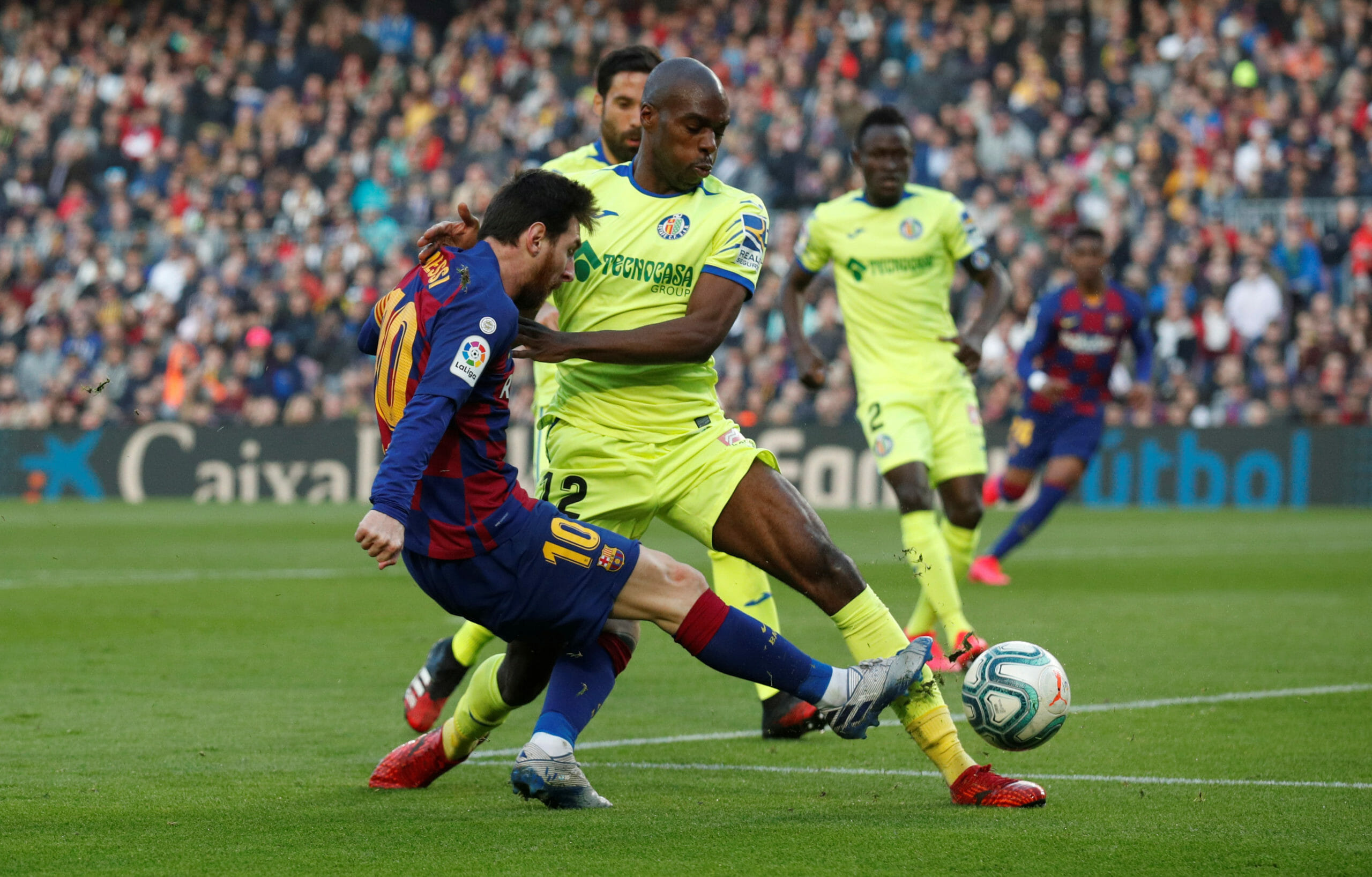 Soccer Football - La Liga Santander - FC Barcelona v Getafe - Camp Nou, Barcelona, Spain - February 15, 2020  Barcelona's Lionel Messi in action with Getafe's Allan Nyom   REUTERS