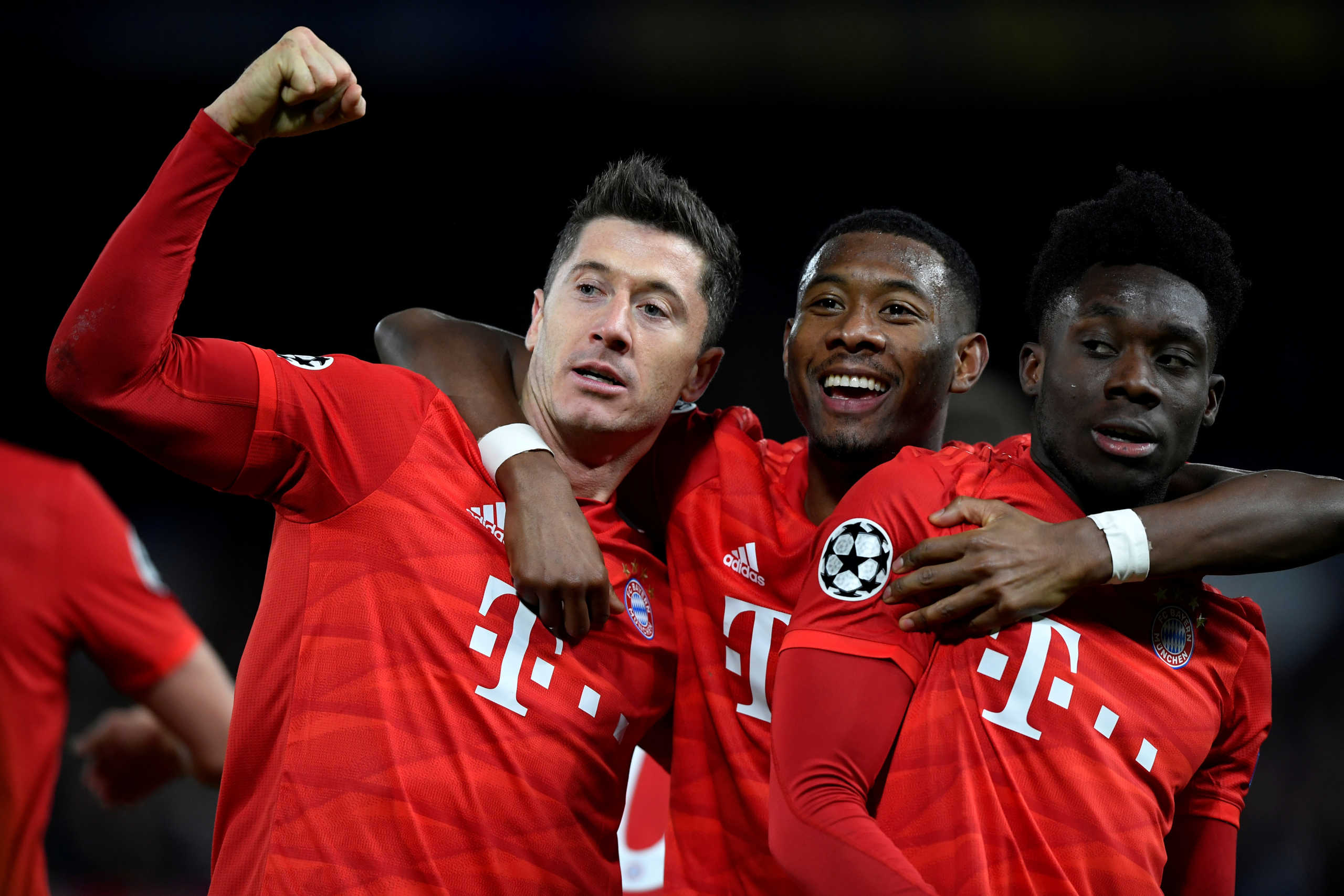 Soccer Football - Champions League - Round of 16 First Leg - Chelsea v Bayern Munich - Stamford Bridge, London, Britain - February 25, 2020  Bayern Munich's Robert Lewandowski celebrates scoring their third goal with teammates David Alaba and Alphonso Davies   REUTERS