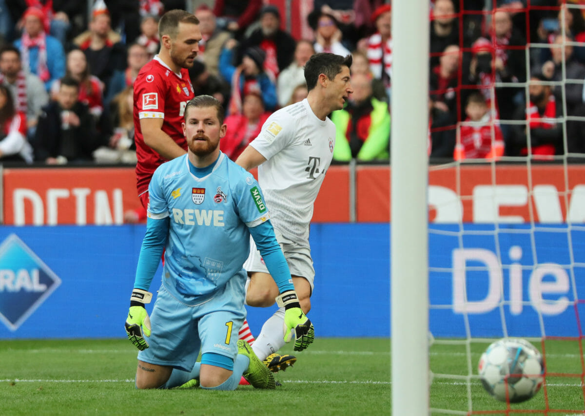 Soccer Football - Bundesliga - FC Cologne v Bayern Munich - RheinEnergieStadion, Cologne, Germany - February 16, 2020  Bayern Munich's Robert Lewandowski celebrates scoring their first goal as FC Cologne's Timo Horn looks dejected   REUTERS