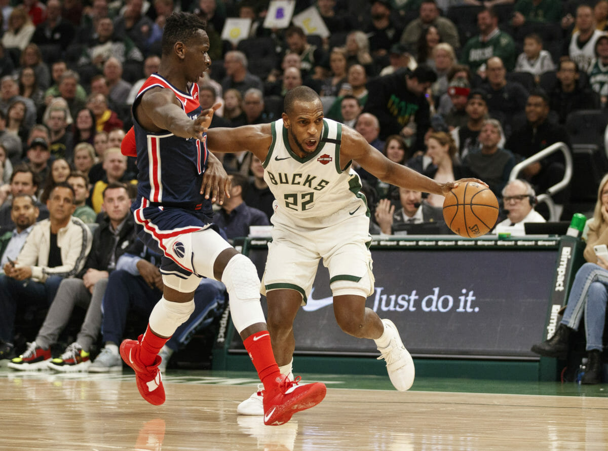 Jan 28, 2020; Milwaukee, Wisconsin, USA;  Milwaukee Bucks forward Khris Middleton (22) drives for the basket against Washington Wizards forward Isaac Bonga (17) during the second quarter at Fiserv Forum. Mandatory Credit: Jeff Hanisch-USA TODAY Sports