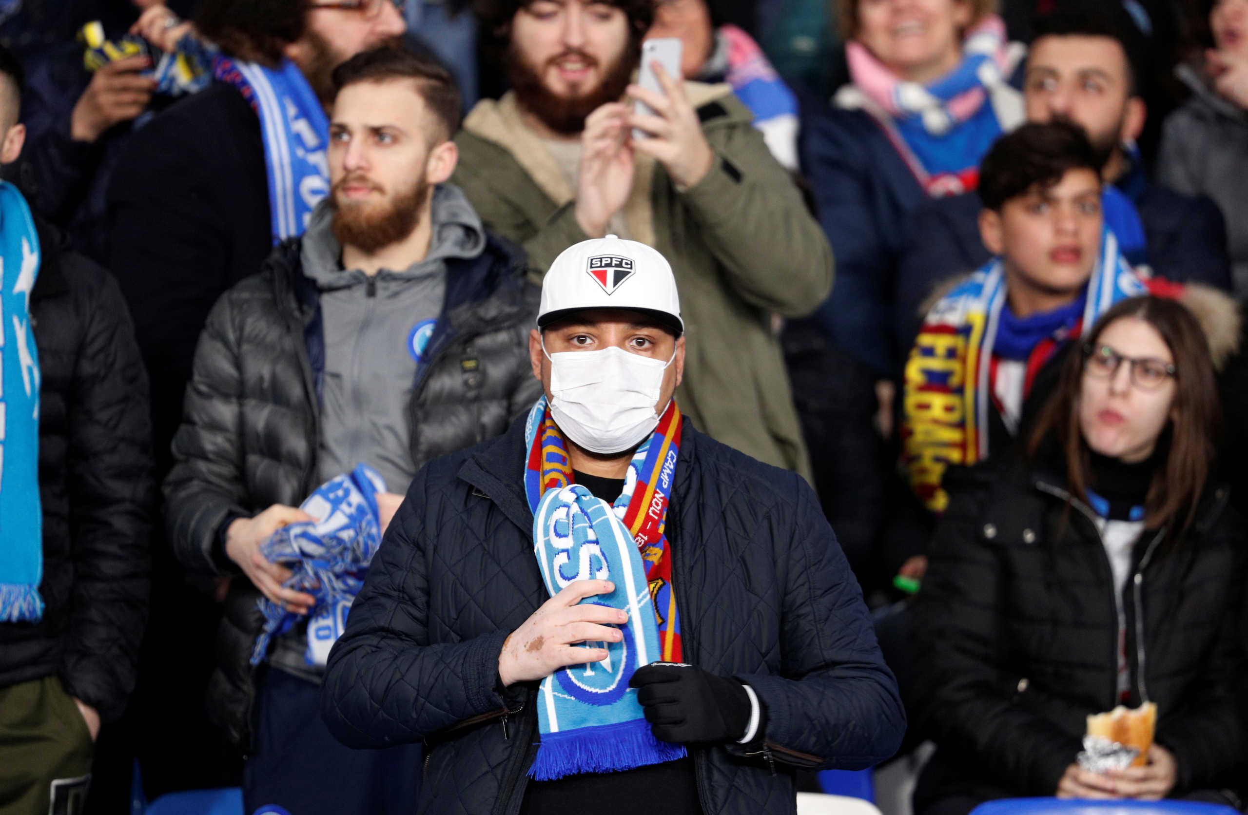 Soccer Football - Champions League - Round of 16 First Leg - Napoli v FC Barcelona - Stadio San Paolo, Naples, Italy - February 25, 2020  A fan wearing a face mask inside the stadium amid concern following a coronavirus outbreak in Italy  REUTERS