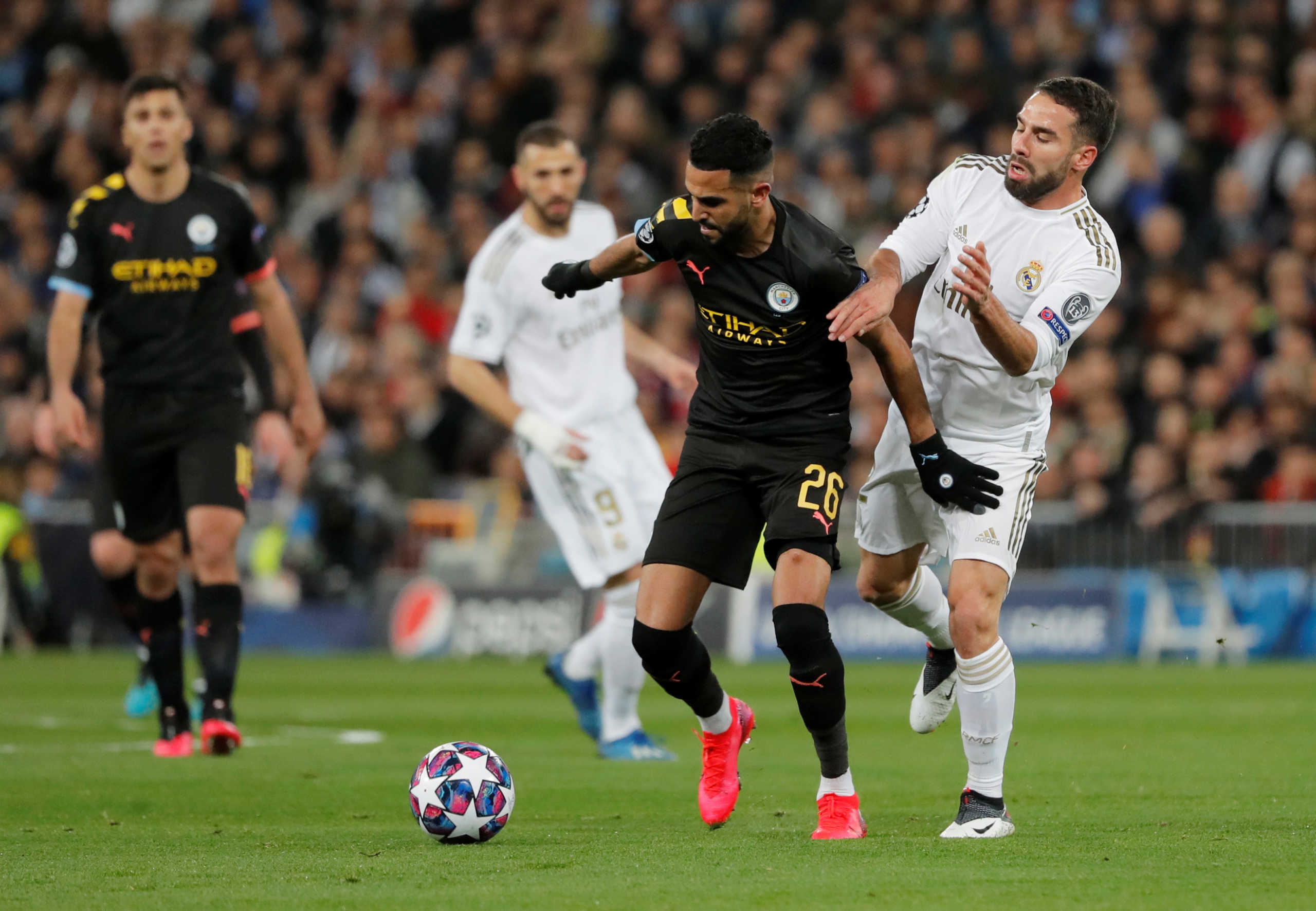 Soccer Football - Champions League - Round of 16 First Leg - Real Madrid v Manchester City - Santiago Bernabeu, Madrid, Spain - February 26, 2020  Manchester City's Riyad Mahrez in action with Real Madrid's Dani Carvajal  REUTERS