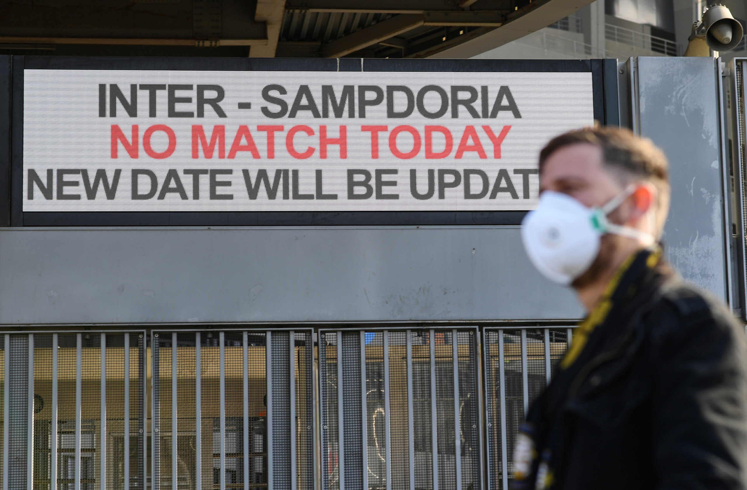 A man wearing a face mask stands outside the San Siro stadium after the Inter Milan v Sampdoria Serie A match was cancelled due to an outbreak of the coronavirus in Lombardy and Veneto, in Milan, Italy, February 23, 2020.REUTERS