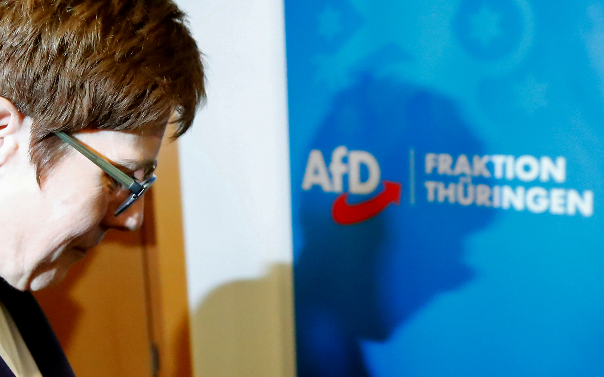 FILE PHOTO: Annegret Kramp-Karrenbauer, chairwoman of Germany's conservative Christian Democratic Union party CDU walks past a sign of Germany's far-right Alternative for Germany (AFD) party following a meeting at the federal parliament of the state of Thuringia in Erfurt, Germany February 7, 2020. REUTERS
