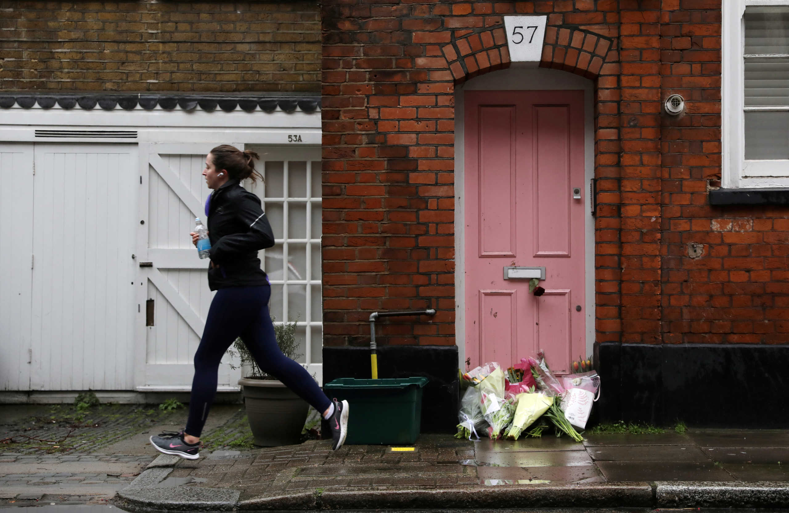 FILE PHOTO: Flowers lie outside British television presenter Caroline Flack's old house in Islington, London, February 16, 2020. REUTERS