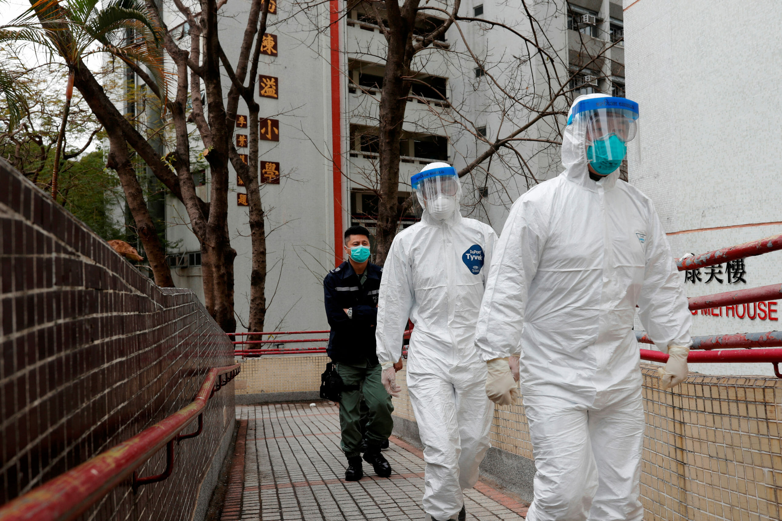 Health workers in protective gears walk as they evacuate residents from a public housing building, following the outbreak of the novel coronavirus, outside Hong Mei House, at Cheung Hong Estate in Hong Kong, China February 11, 2020. REUTERS