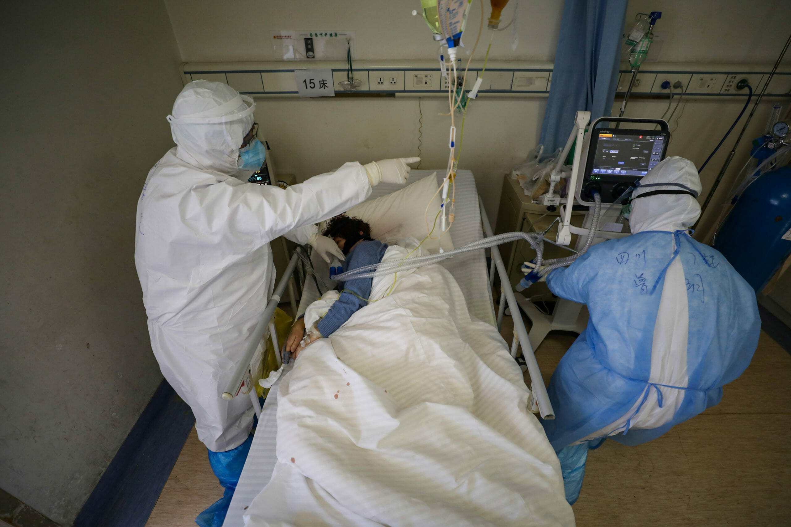 Medical workers in protective suits attend to a patient inside an isolated ward of Wuhan Red Cross Hospital in Wuhan, the epicentre of the novel coronavirus outbreak, in Hubei province, China February 16, 2020. Picture taken February 16, 2020. China Daily via REUTERS  ATTENTION EDITORS - THIS IMAGE WAS PROVIDED BY A THIRD PARTY. CHINA OUT.