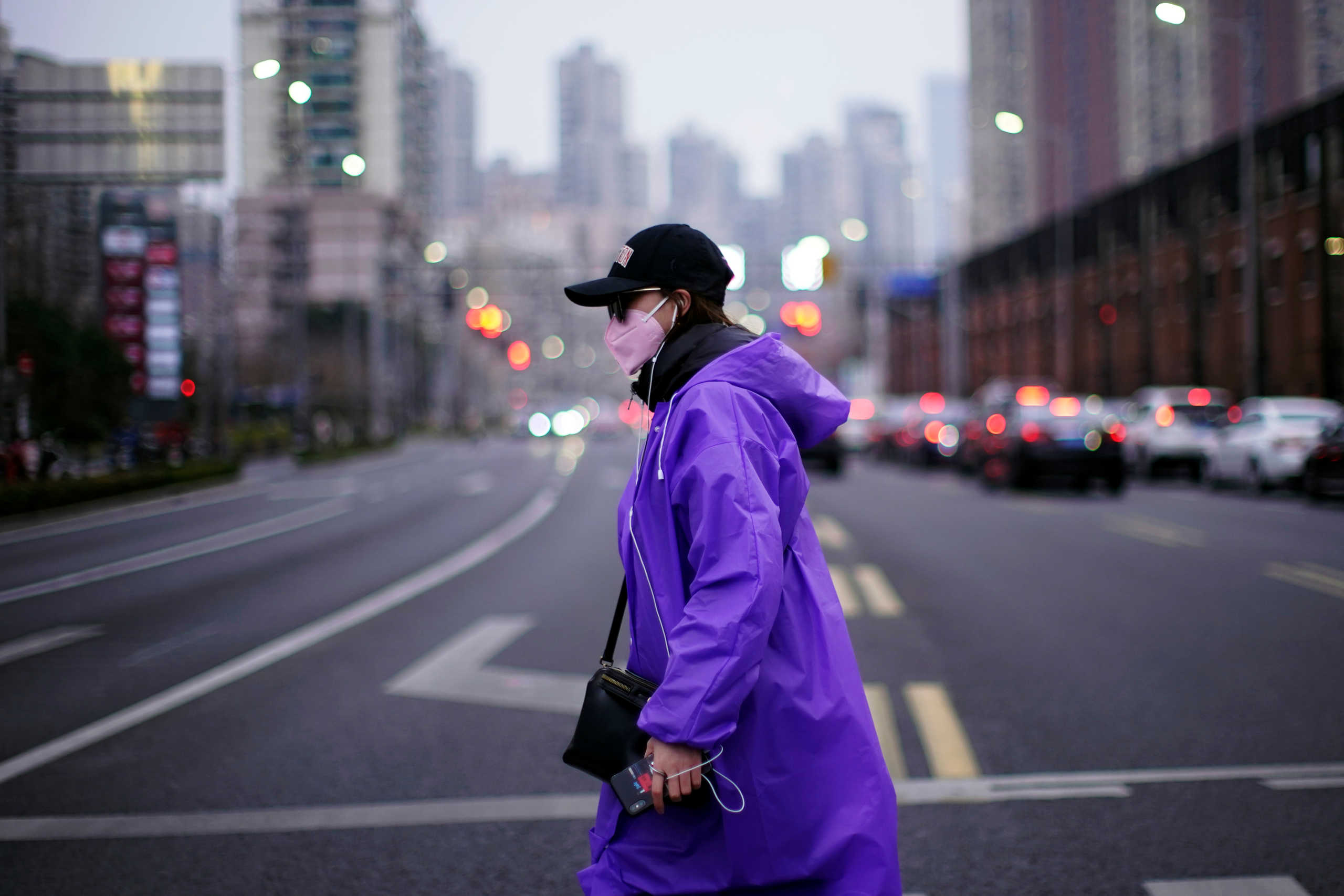 A woman wearing a face mask is seen on a street in downtown Shanghai, China, as the country is hit by an outbreak of a new coronavirus, February 26, 2020. REUTERS
