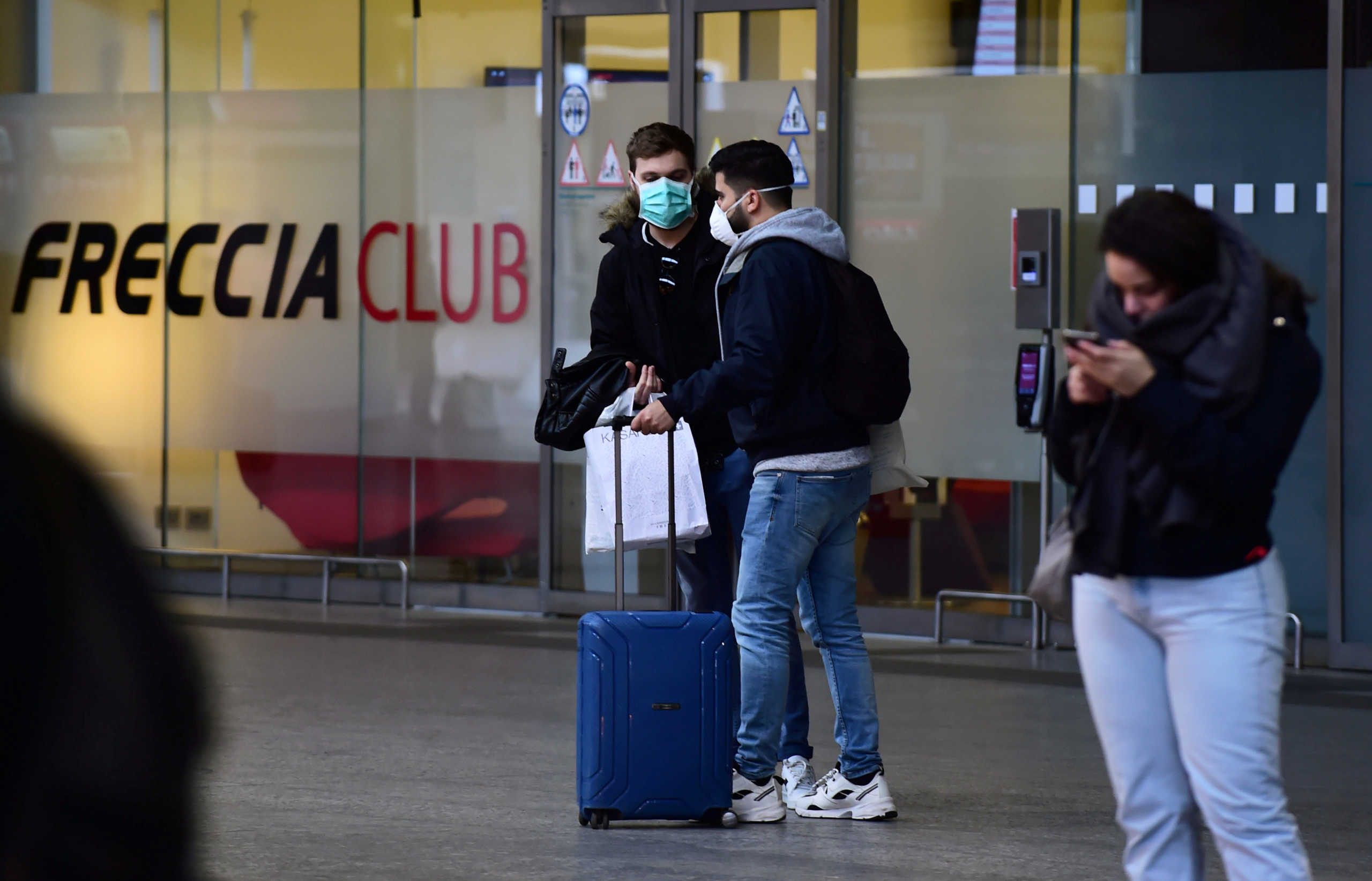 People wear protective masks at Porta Nuova rail station, as a coronavirus outbreak continues to grow in northern Italy, in Turin, Italy, February 27, 2020.  REUTERS