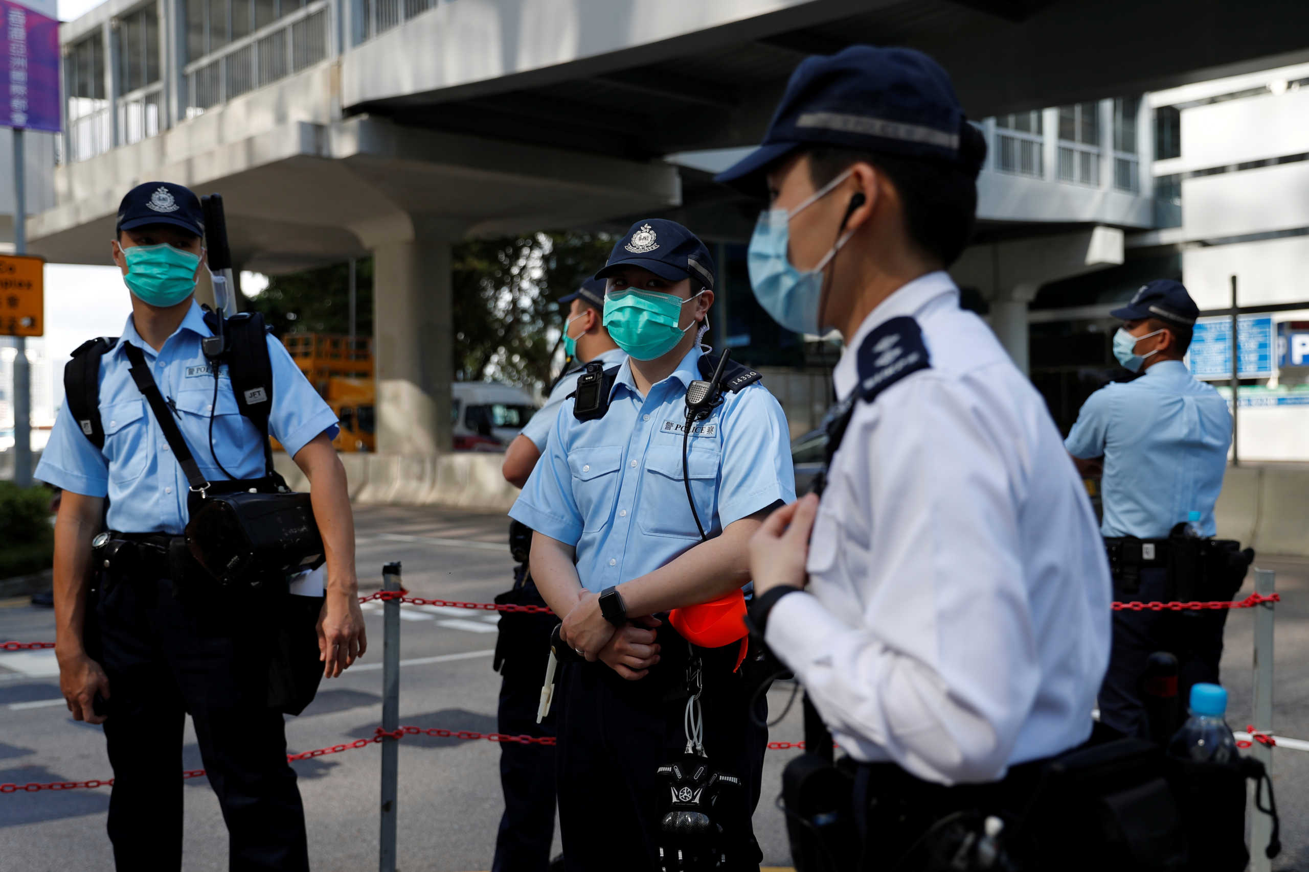 Police wear surgical masks as they stand guard outside the Legislative Council, following the outbreak of the new coronavirus, in Hong Kong, China February 26, 2020. REUTERS