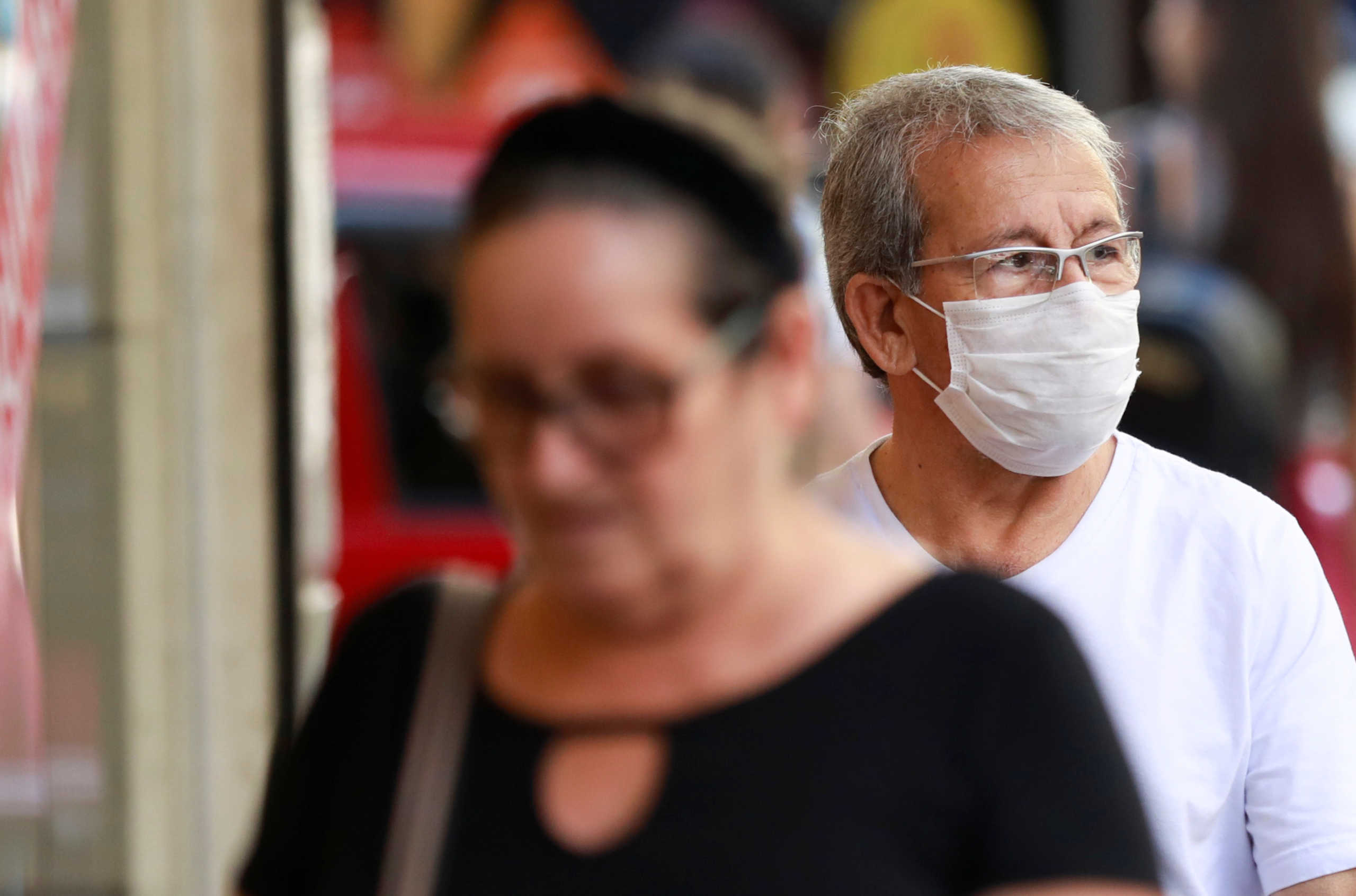 A man wearing a mask, following the coronavirus outbreak, walks in Porto Alegre, Brazil February 27, 2020. REUTERS