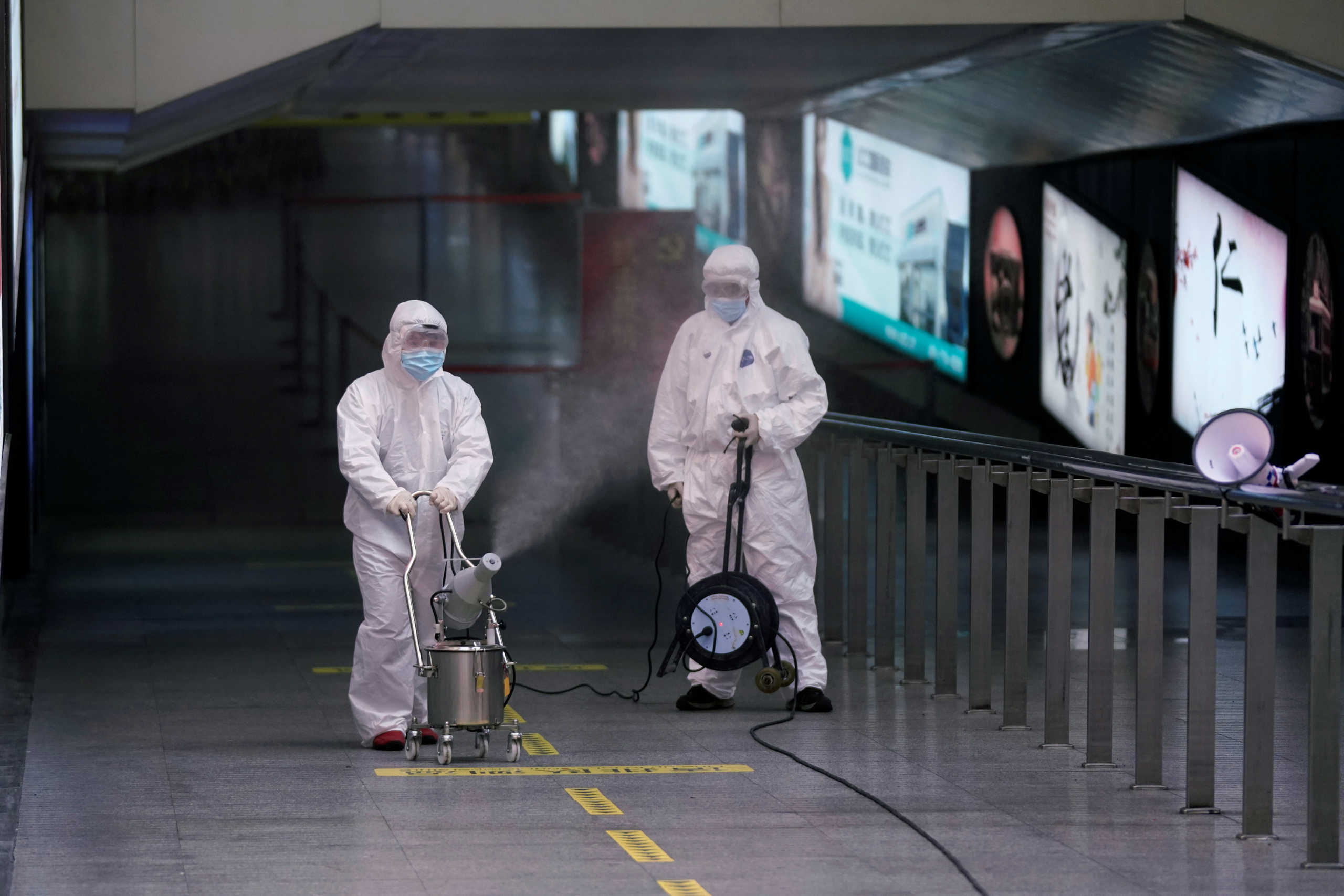 Workers with sanitizing equipment disinfect at the Shanghai railway station in Shanghai, China, as the country is hit by an outbreak of a new coronavirus, February 27, 2020. REUTERS