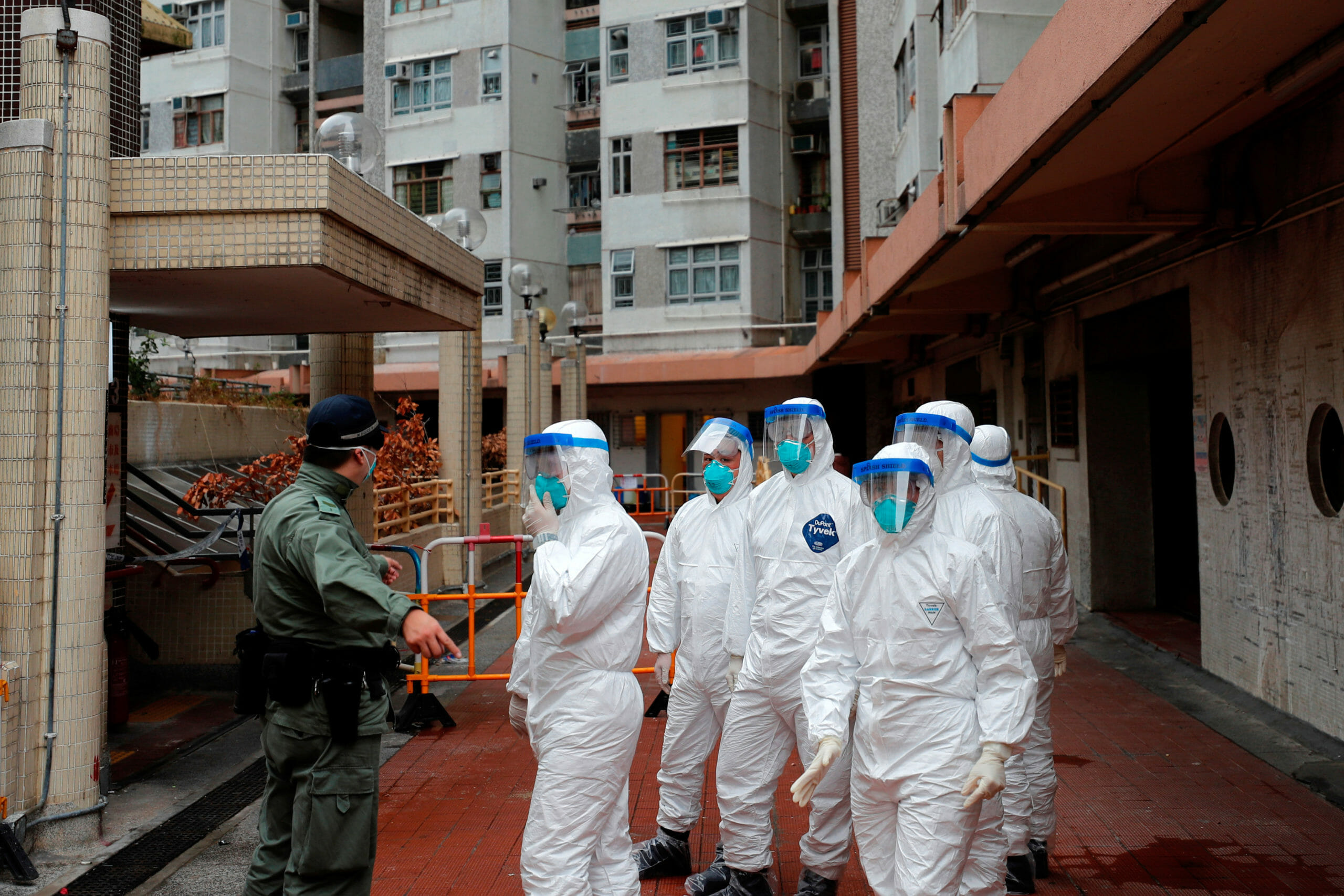 Police in protective gear wait to evacuate residents from a public housing building, following the outbreak of the novel coronavirus, in Hong Kong, China February 11, 2020. REUTERS