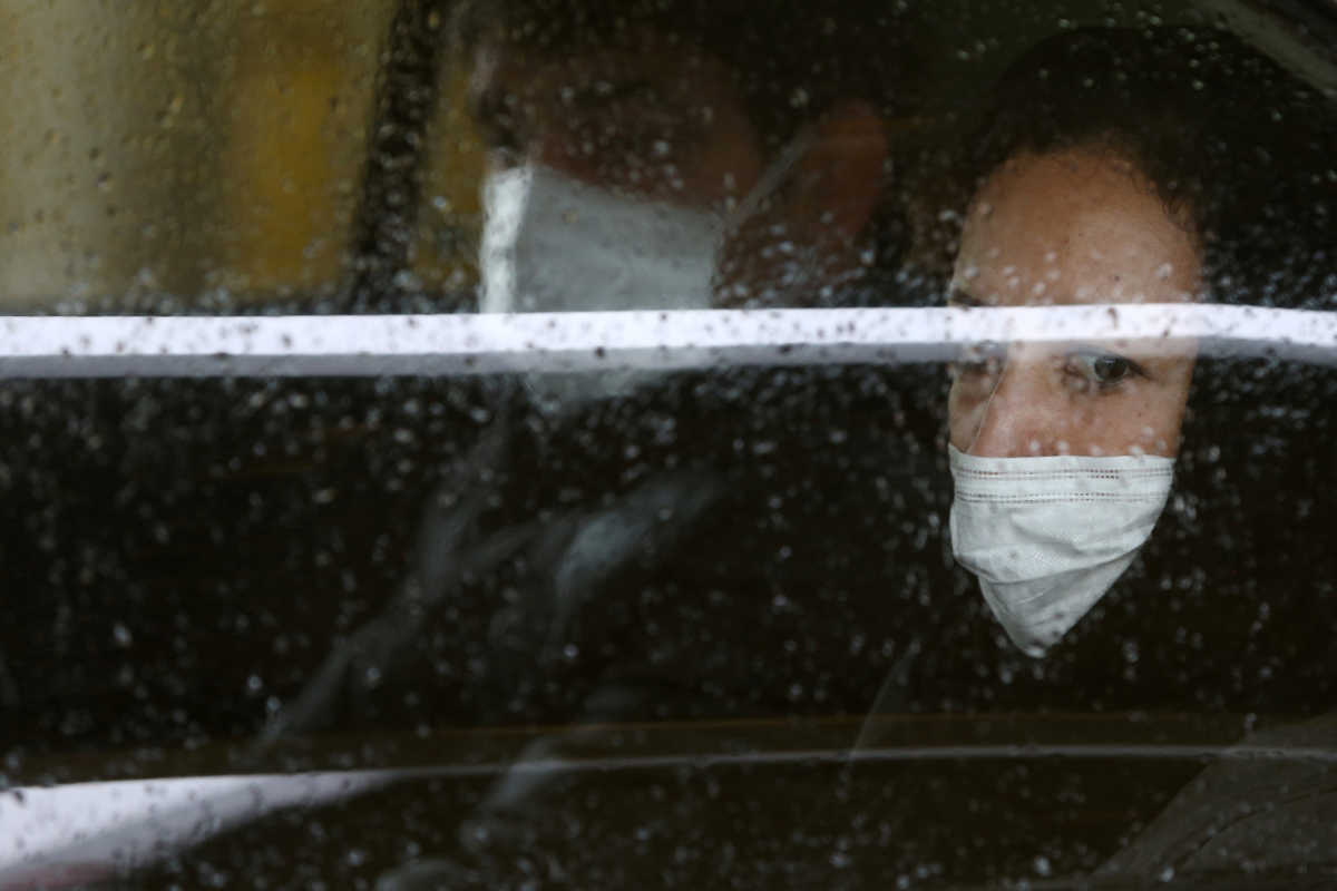 Iranian people wear protective masks to prevent contracting coronavirus, as they sit in taxi in Tehran, Iran February 25, 2020.WANA (West Asia News Agency)