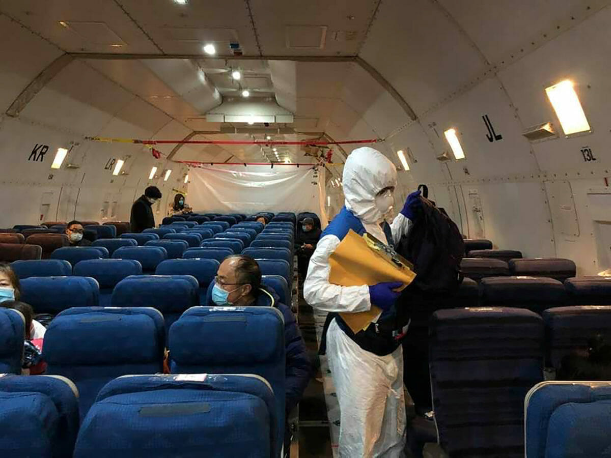Staff from the U.S. embassy walk in a cargo plane, chartered by the U.S. State Department to evacuate Americans and Canadians from China due to the outbreak of novel Coronavirus, during the boarding process at Wuhan Tianhe International Airport in Wuhan, China February 7, 2020.  Courtesy of Edward Wang via REUTERS. THIS IMAGE HAS BEEN SUPPLIED BY A THIRD PARTY. MANDATORY CREDIT