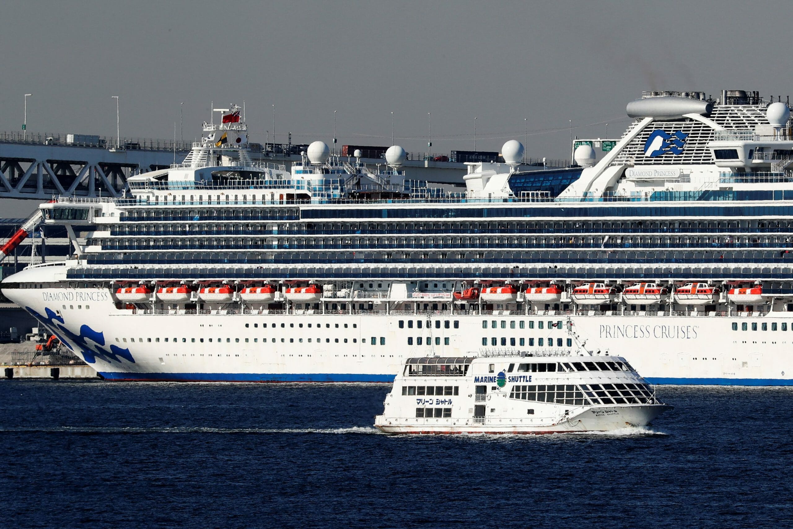 A sightseeing boat moves past the cruise ship Diamond Princess, where dozens of passengers were tested positive for coronavirus, at the Daikoku Pier Cruise Terminal in Yokohama, south of Tokyo, Japan February 10, 2020. REUTERS