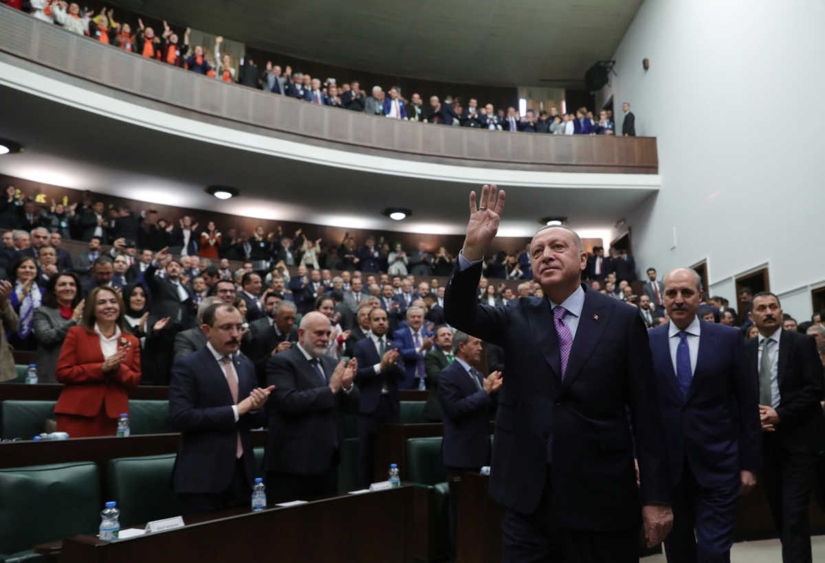 Turkish President Tayyip Erdogan greets members of his ruling AK Party during a meeting at the Parliament in Ankara, Turkey, February 26, 2020. Turkish Presidential Press Office