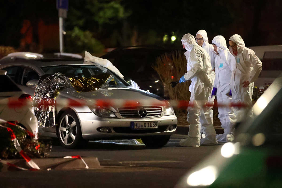 Forensic experts work around a damaged car after a shooting in Hanau near Frankfurt, Germany, February 20, 2020.     REUTERS