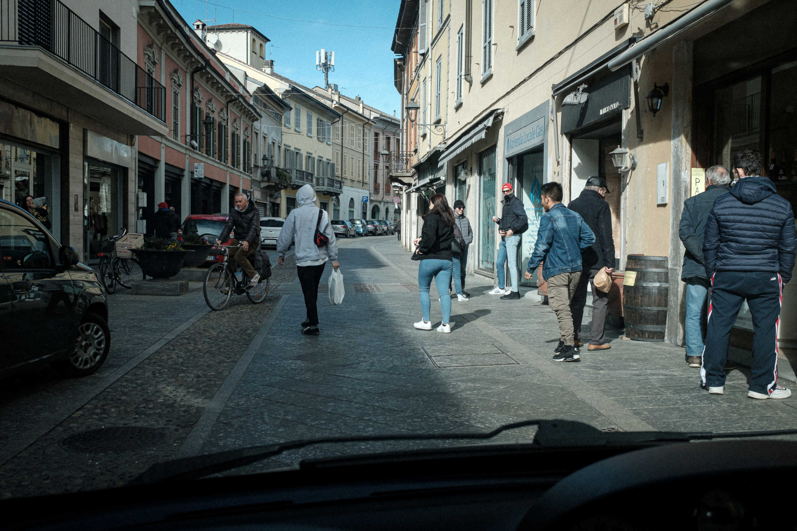 Life inside a red zone: People gather on a shopping street in Codogno, one of the towns on lockdown due to a coronavirus outbreak, in this picture taken by schoolteacher Marzio Toniolo through his car window in Codogno, Italy, February 27, 2020. Picture taken February 27, 2020. Marzio Toniolo