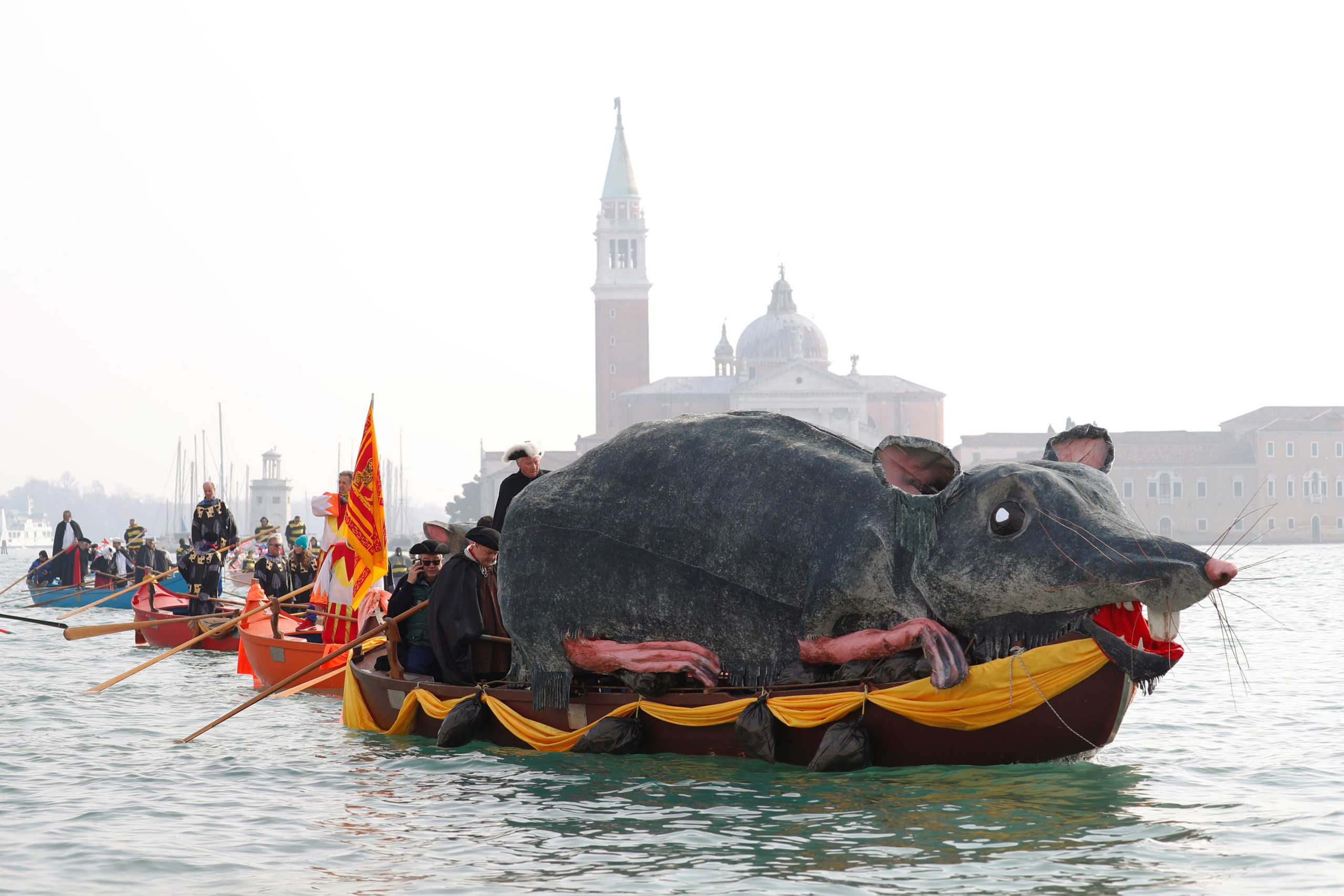 Venetians row during the masquerade parade on the Grand Canal during the Carnival in Venice, Italy, February 9, 2020. REUTERS