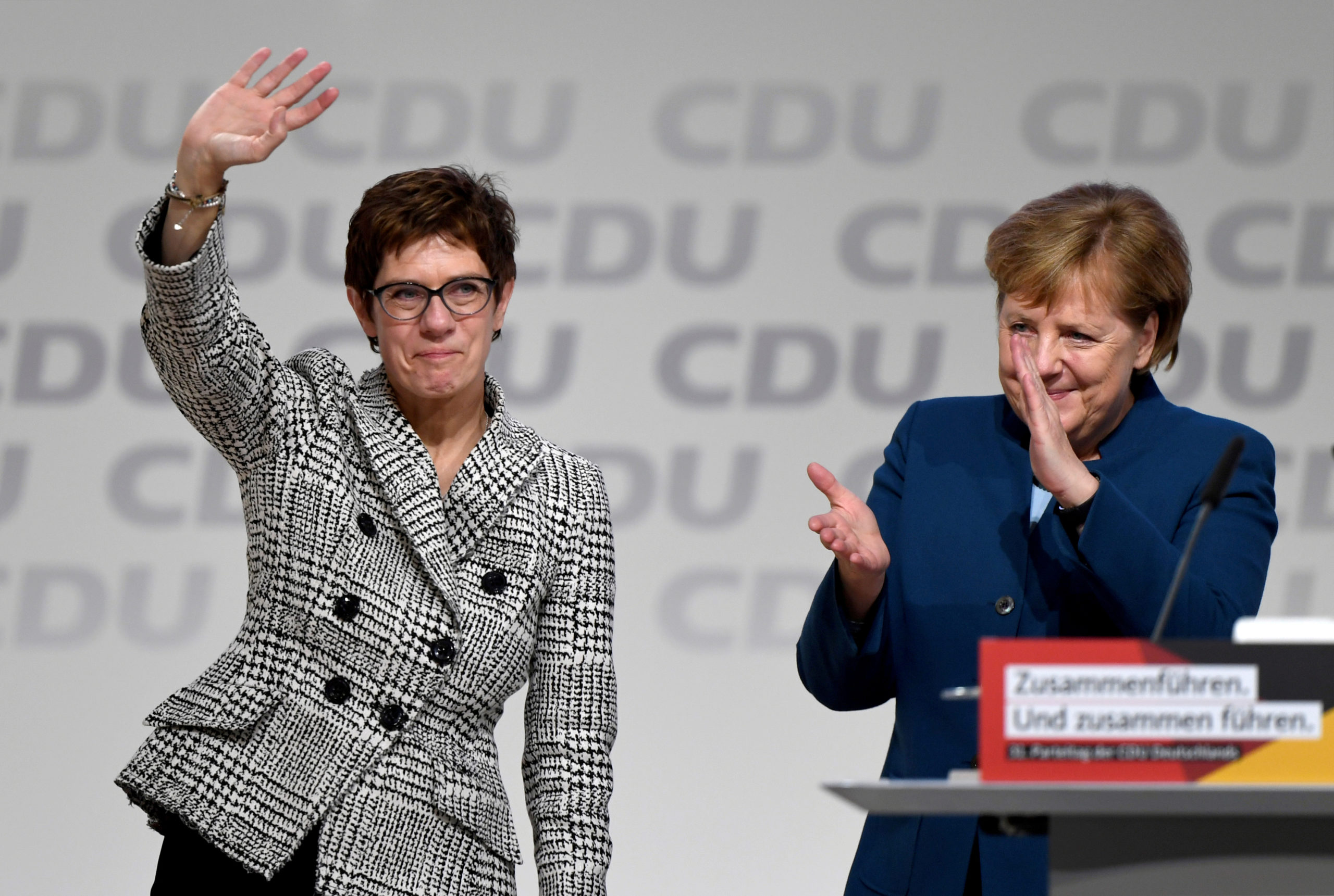 FILE PHOTO: Annegret Kramp-Karrenbauer waves next to German Chancellor Angela Merkel after being elected as the party leader during the Christian Democratic Union (CDU) party congress in Hamburg, Germany, December 7, 2018. REUTERS
