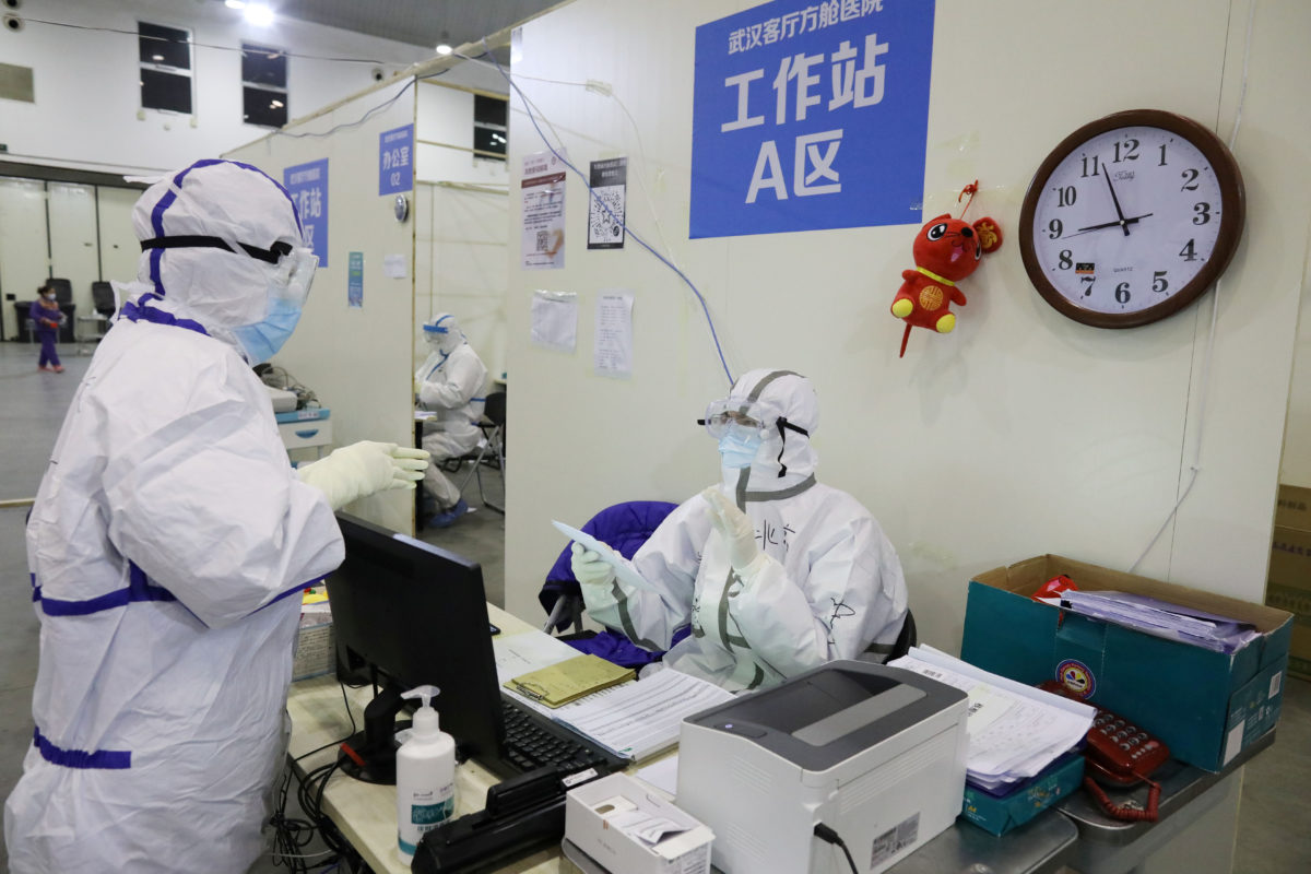 Medical workers in protective suits are seen inside the Wuhan Parlor Convention Center that has been converted into a makeshift hospital following an outbreak of the novel coronavirus, in Wuhan, Hubei province, China February 15, 2020. Picture taken February 15, 2020. China Daily via REUTERS  ATTENTION EDITORS - THIS IMAGE WAS PROVIDED BY A THIRD PARTY. CHINA OUT.
