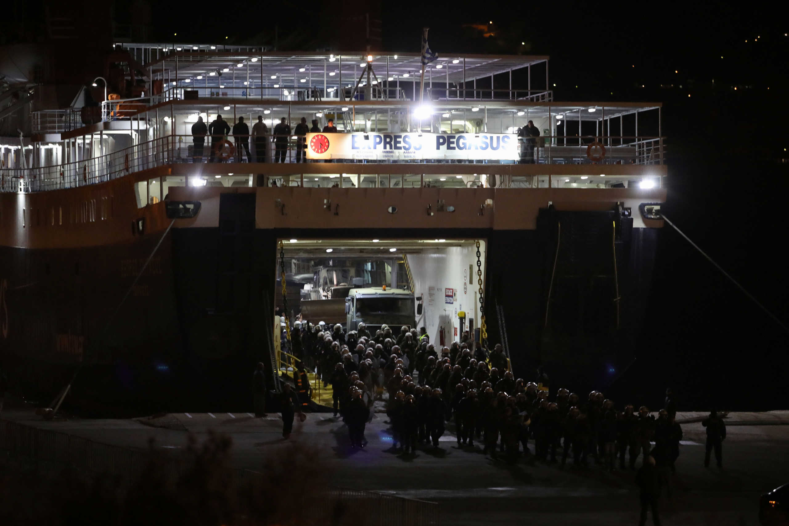 Riot police reinforcements sent for monitoring the creation of a new closed migrant detention centre, arrive on a ferry at the port of Mytilene on the island of Lesbos, Greece, February 25, 2020. REUTERS