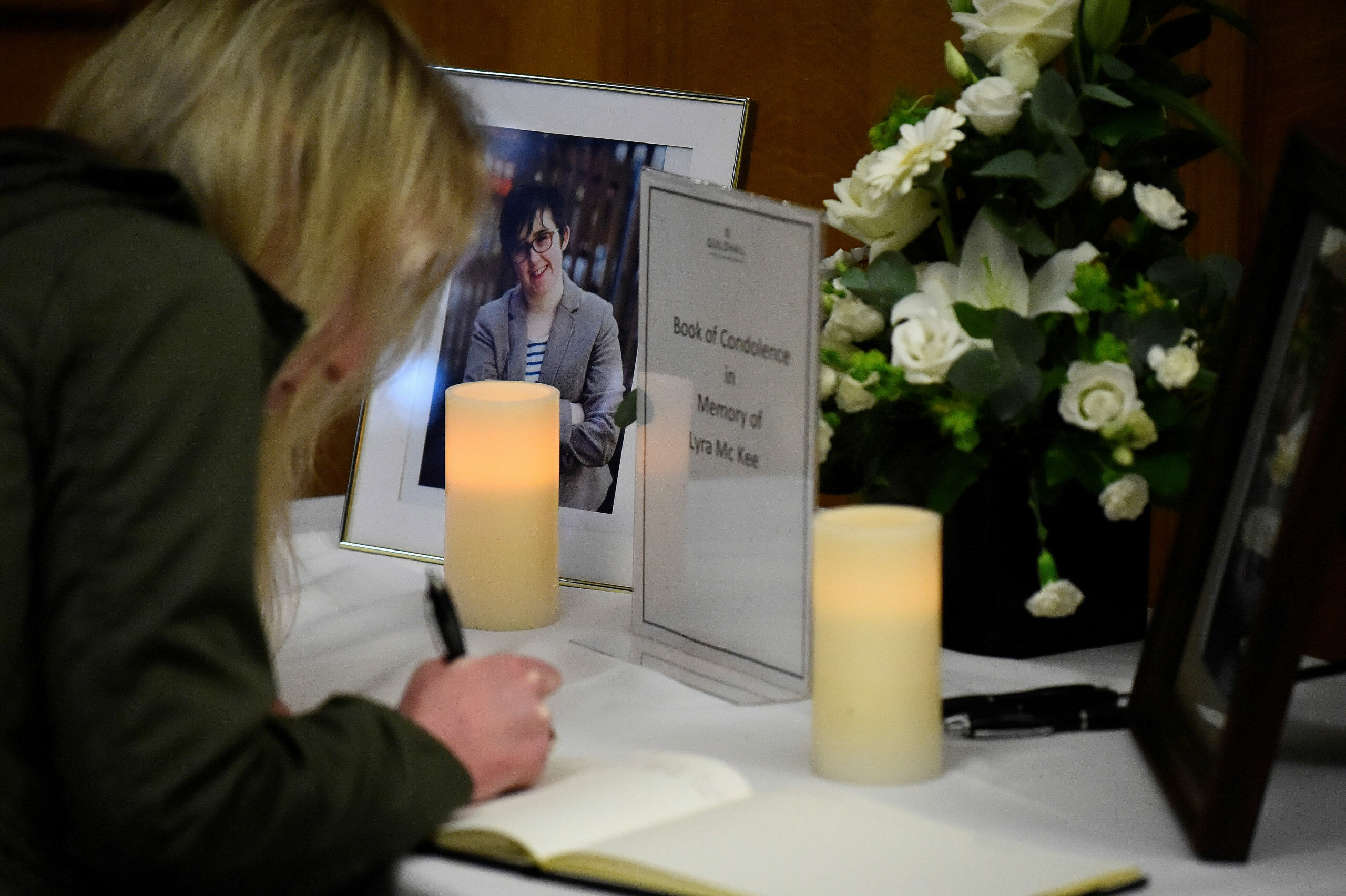 FILE PHOTO: A woman signs a book of condolences in the Guildhall for the 29-year-old journalist Lyra McKee who was shot dead in Londonderry, Northern Ireland April 20, 2019. REUTERS