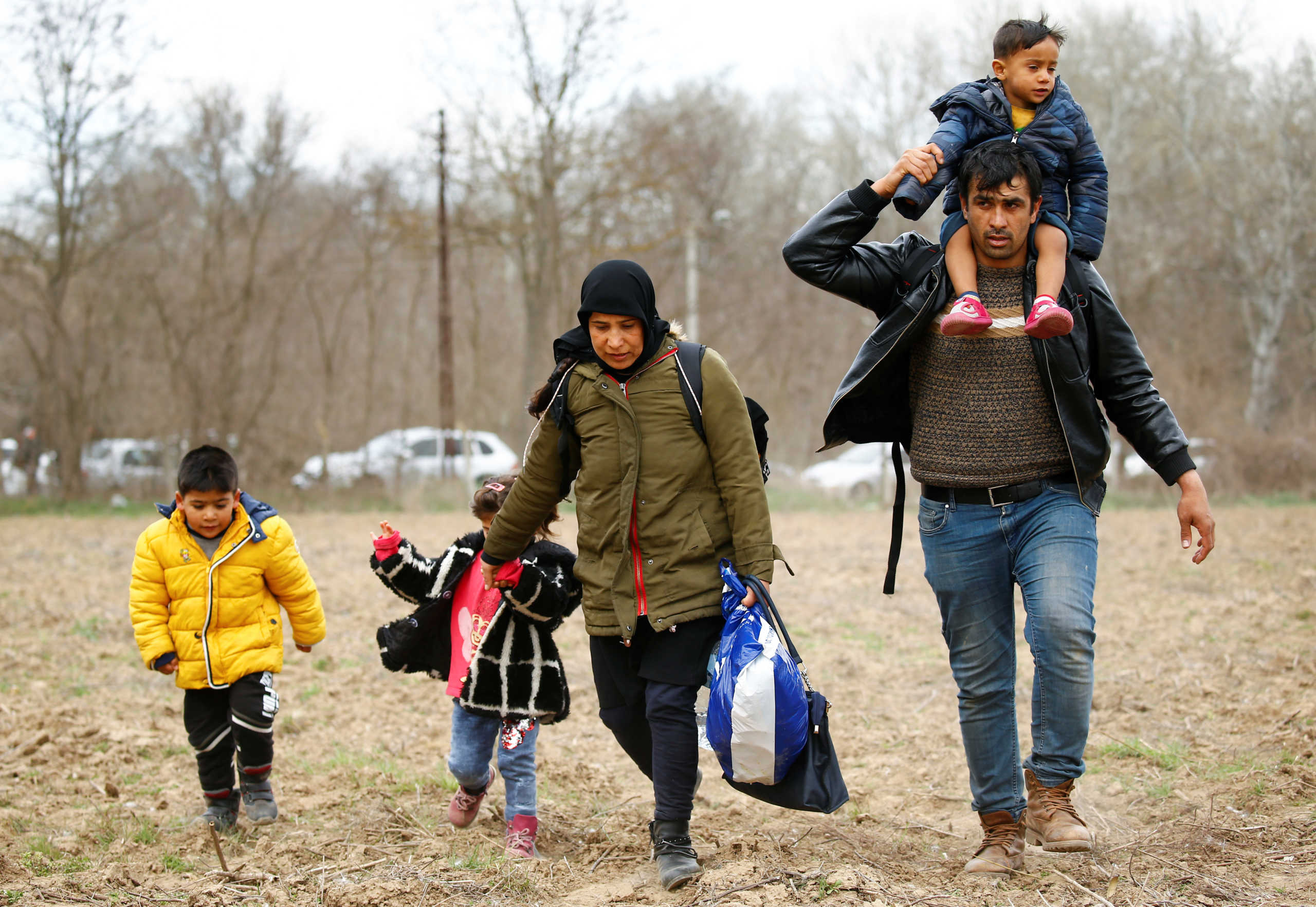 Migrants walk to the Turkey's Pazarkule border crossing with Greece's Kastanies, in Pazarkule, Turkey, February 28, 2020. REUTERS