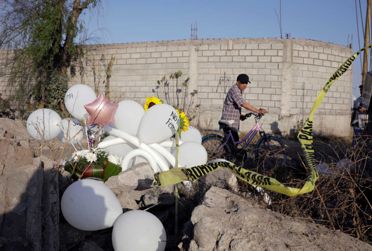 A man looks on next to white balloons and flowers at the site where the body of seven-year old Fatima Cecilia Aldrighett, who went missing on February 11, was discovered over the weekend inside a plastic garbage bag in Mexico City, Mexico, February 17, 2020. REUTERS