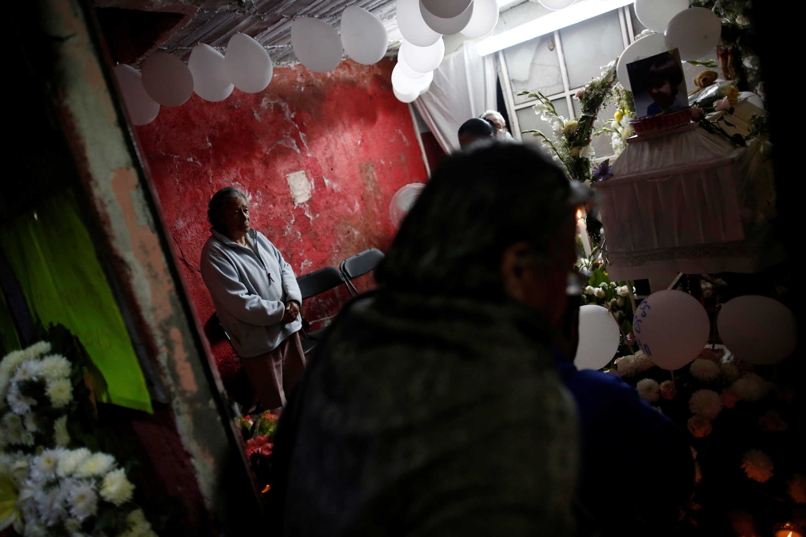 People pay their respects near the coffin of Fatima Cecilia Aldrighett, 7, who went missing on February 11 and whose body was discovered over the weekend inside a plastic garbage bag, at her house in Mexico City, Mexico, February 17, 2020. REUTERS