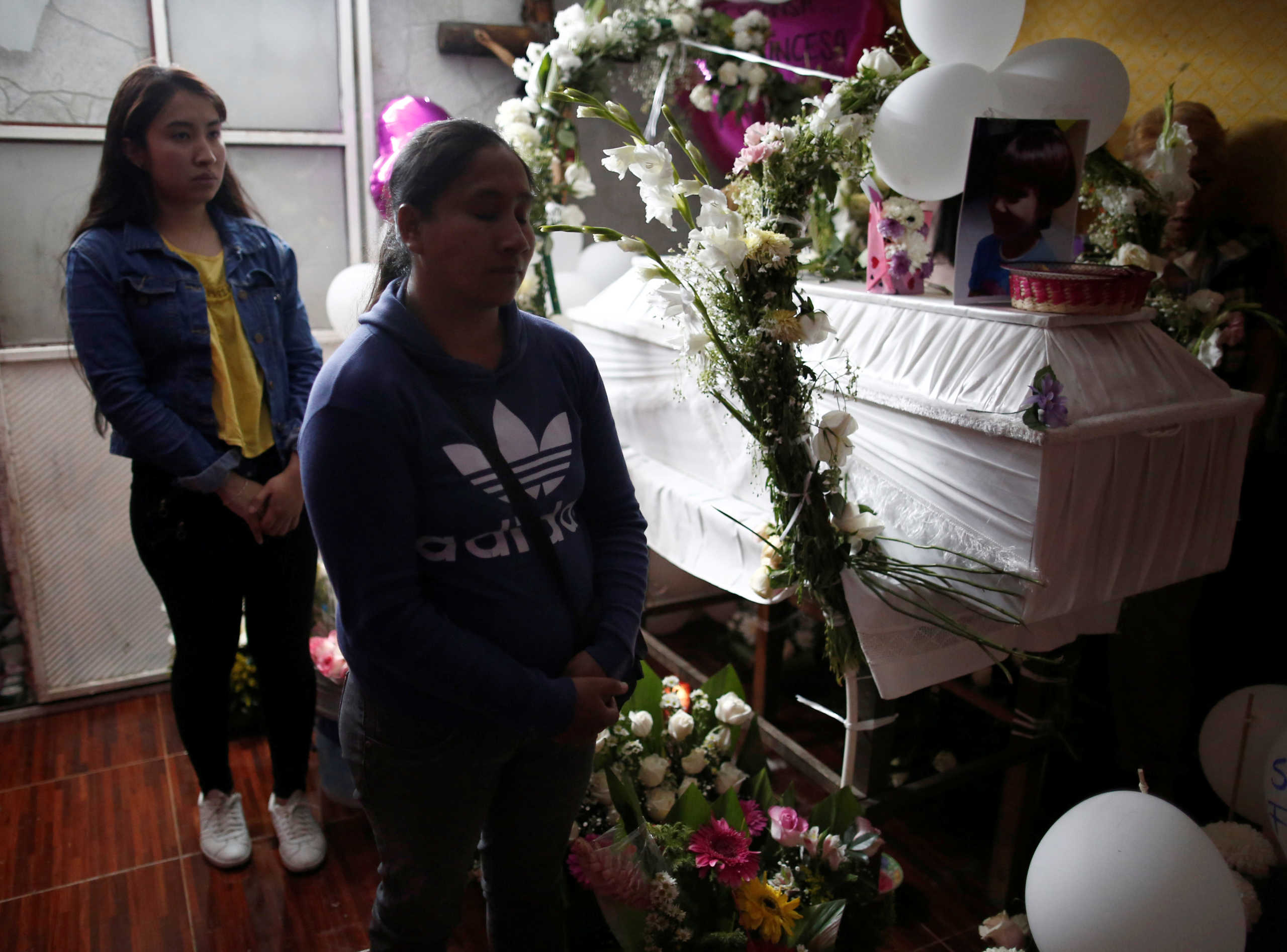 People pay their respects near the coffin of Fatima Cecilia Aldrighett, 7, who went missing on February 11 and whose body was discovered over the weekend inside a plastic garbage bag, at her house in Mexico City, Mexico, February 17, 2020. REUTERS