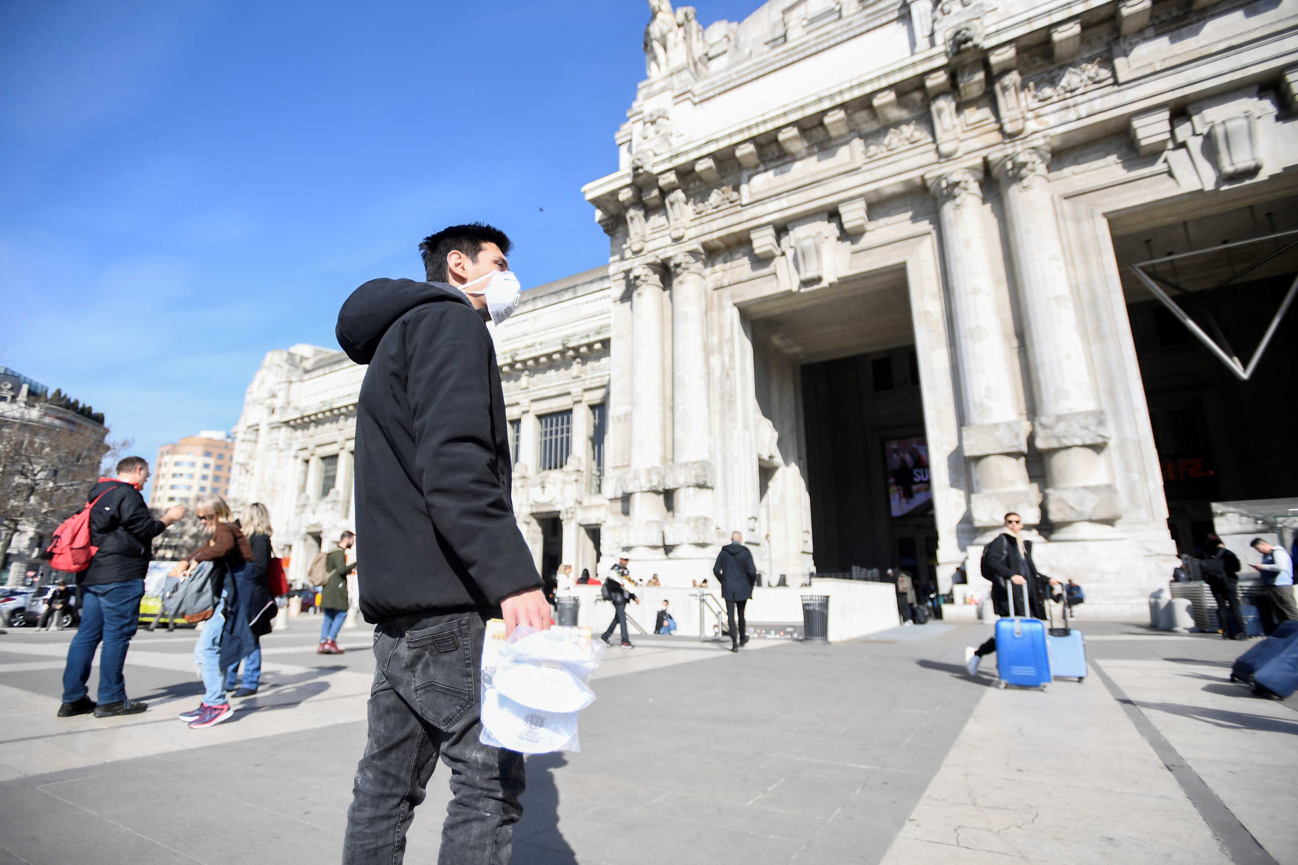 A street vendor sells face masks outside the central railway station, after a coronavirus outbreak, in Milan, Italy February 24, 2020. REUTERS