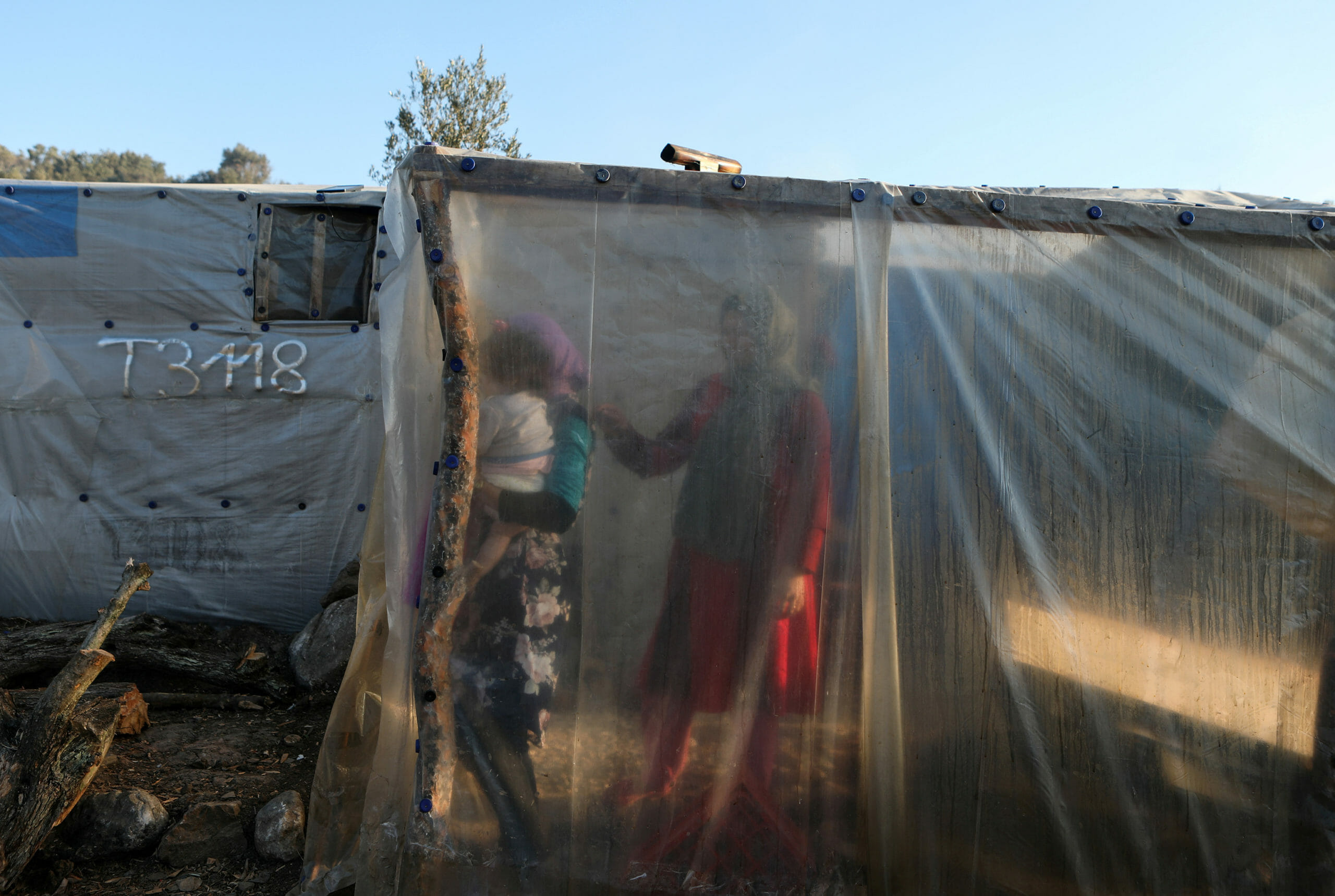 Migrants are seen inside a temporary shelter at a camp for refugees and migrants next to the Moria camp, on the island of Lesbos, Greece, January 22, 2020. REUTERS