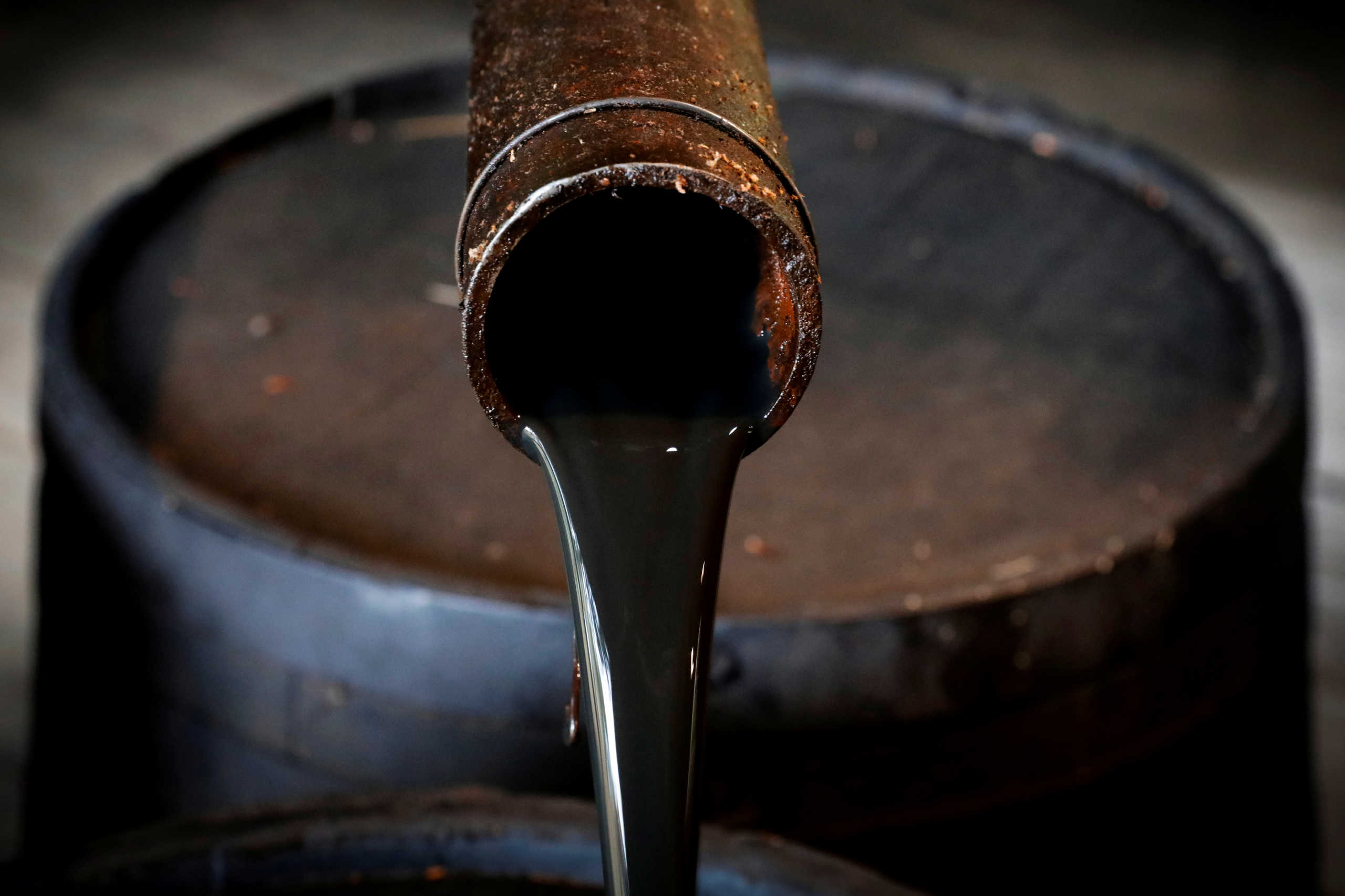 FILE PHOTO: Oil pours out of a spout from Edwin Drake's original 1859 well that launched the modern petroleum industry at the Drake Well Museum and Park in Titusville, Pennsylvania U.S., October 5, 2017. REUTERS