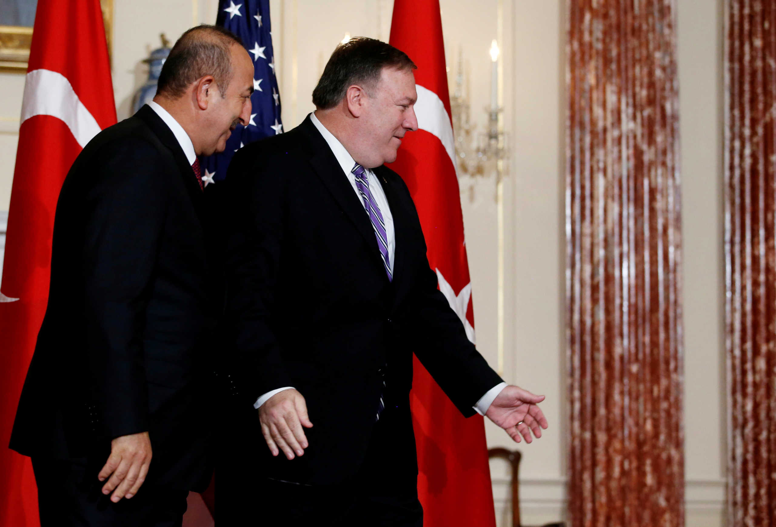 U.S. Secretary of State Mike Pompeo leads Turkish Foreign Minister Mevlut Cavusoglu out of the room after shaking hands with him in front of the news media at the State Department in Washington, U.S., June 4, 2018. REUTERS
