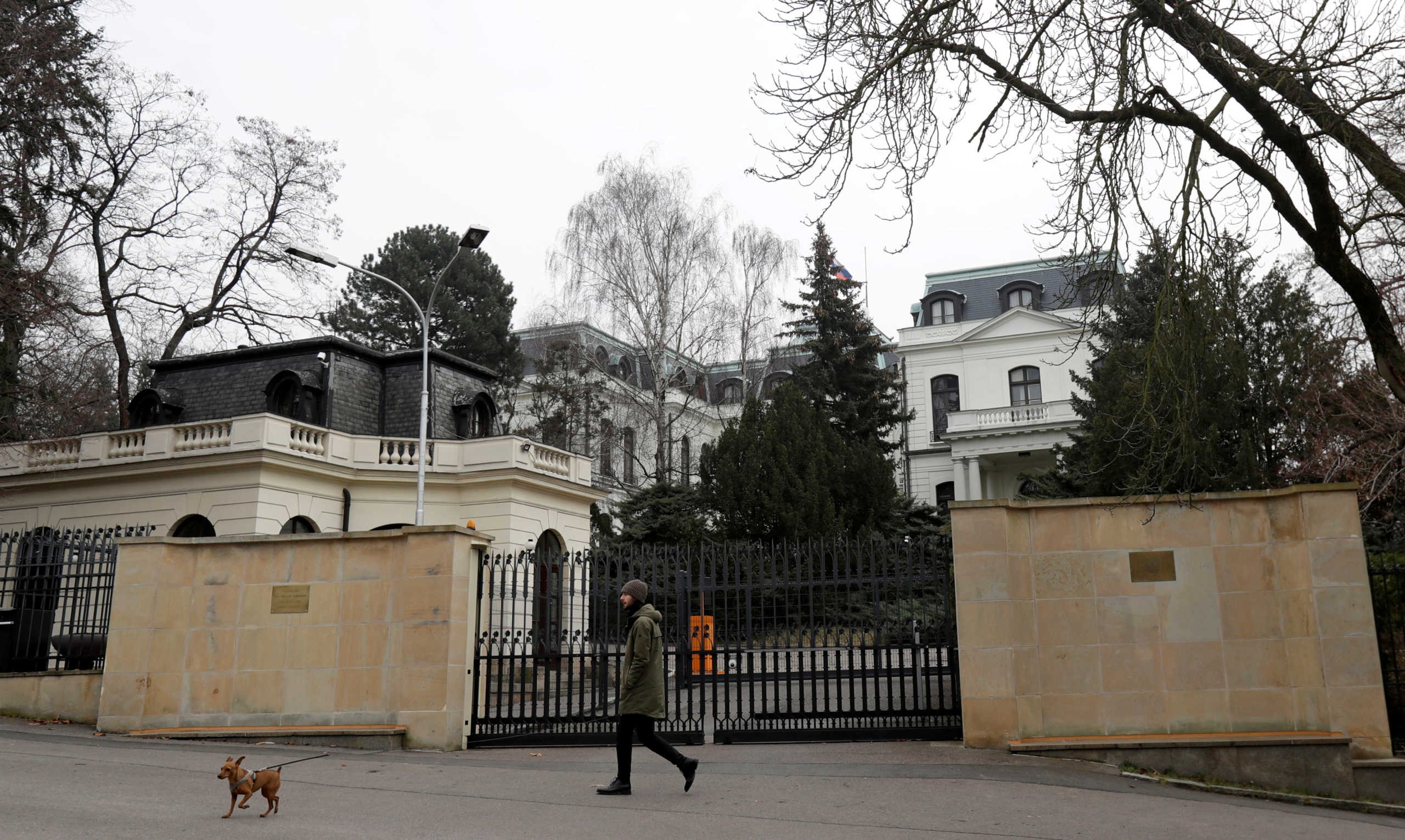 FILE PHOTO: A man walks his dog past the Russian embassy in Prague, Czech Republic, March 26, 2018. REUTERS