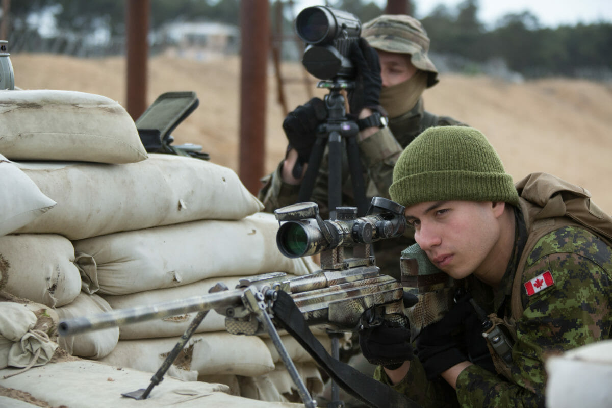 Private Andres Hurtado takes aim with a Polish sniper rifle while Corporal Sebastian Rumniak, with the 6th Polish Brigade, verifies the target for him during Exercise ORZEL ALERT at the Joanna Training Ranges near Zagan, Poland on May 7, 2014.

Photo Jacek Szymanski CF Combat Camera
IS2014-7174-002