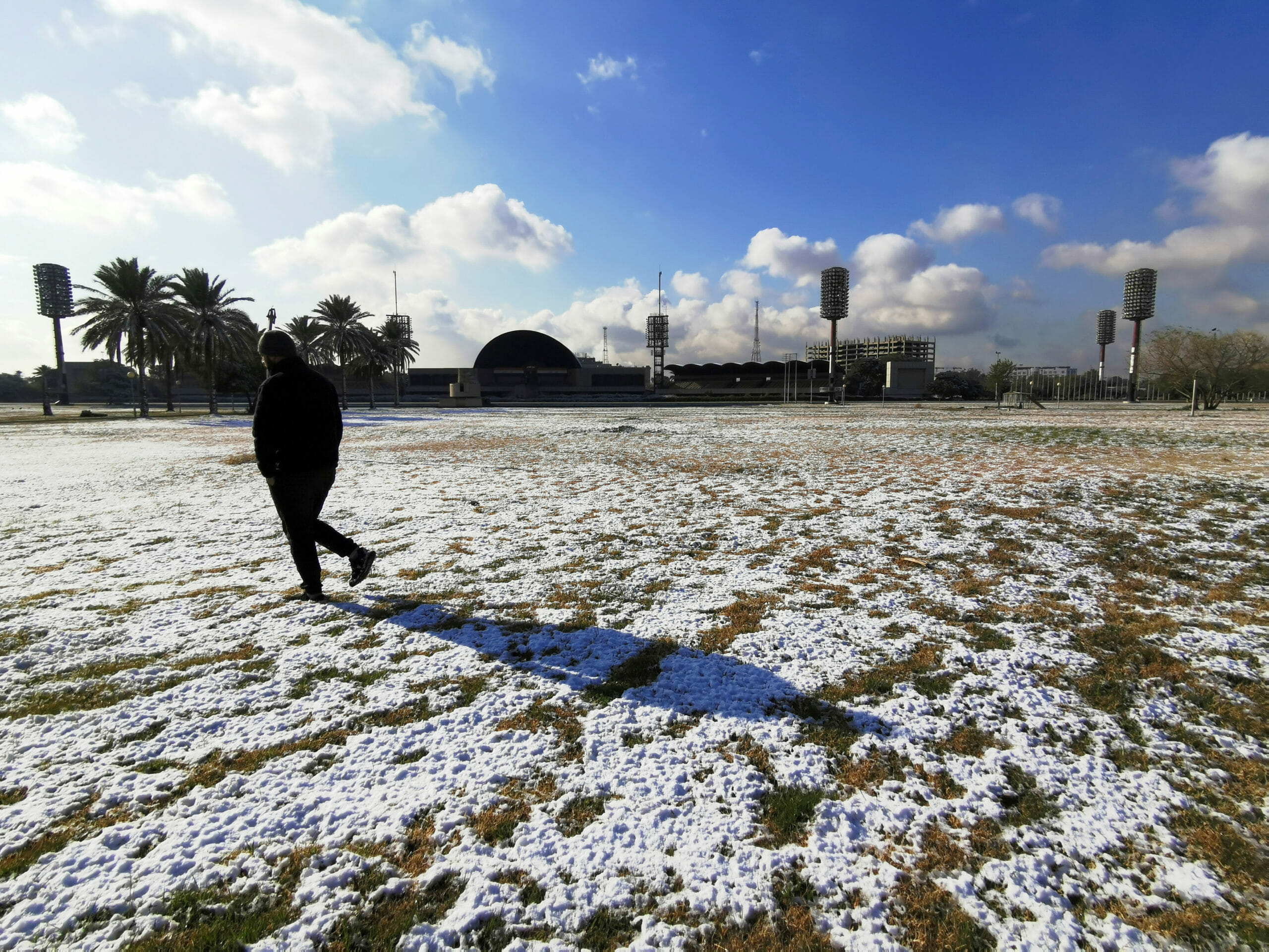 An Iraqi man walks on the snow in Baghdad, Iraq February 11, 2020. REUTERS
