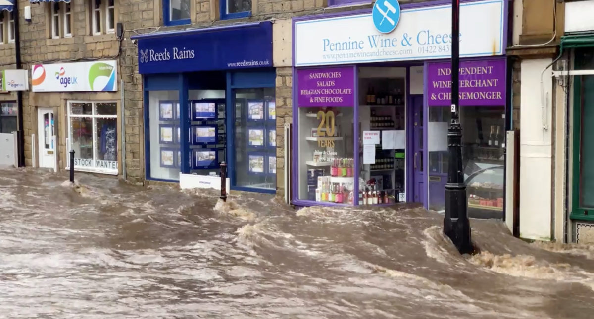 A flooded street is seen after Storm Ciara downpour in Hebden Bridge, West Yorkshire, Britain February 9, 2020 in this still image obtained from social media video.  Courtesy of THE AFGHAN RUG SHOP