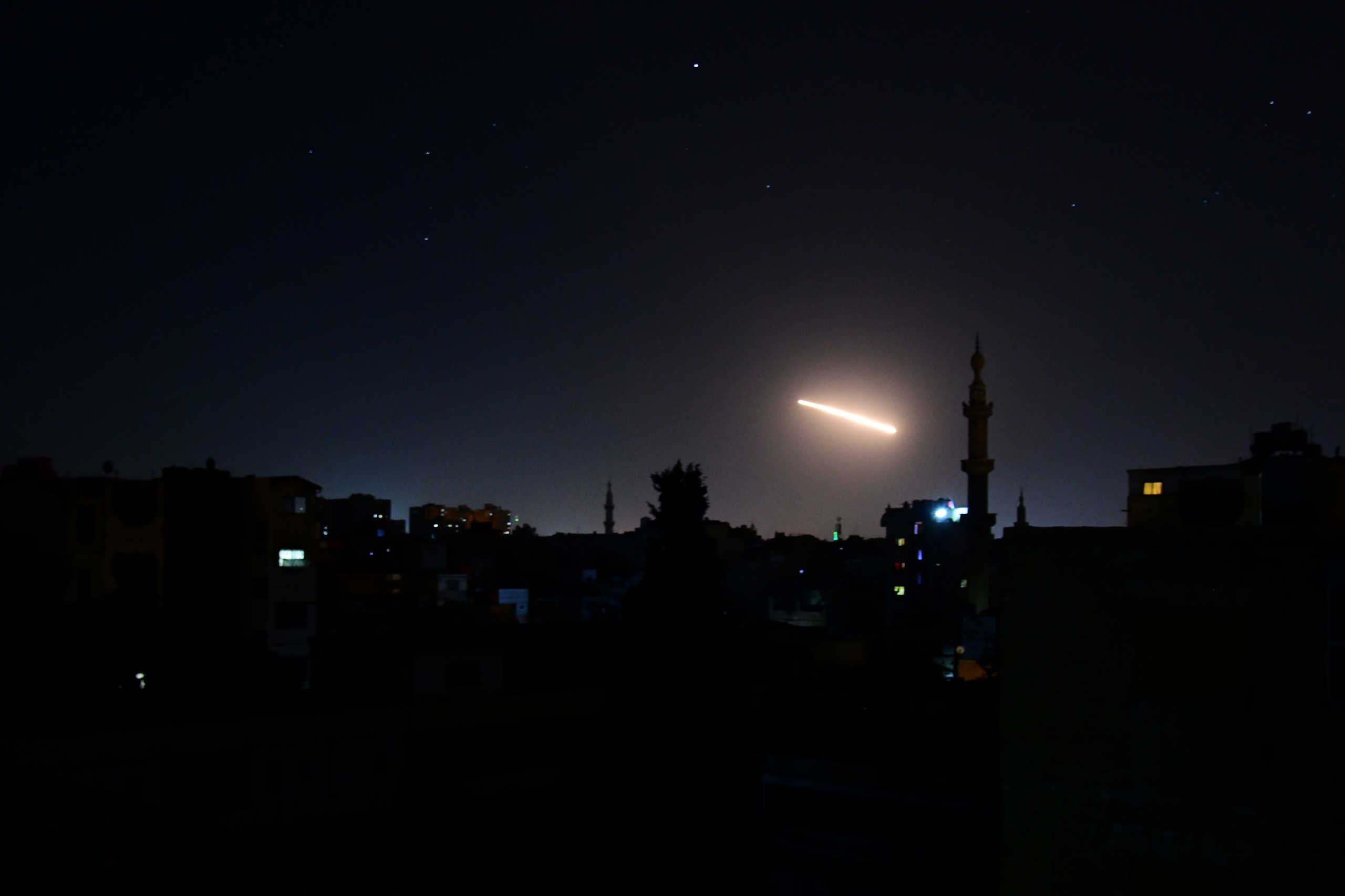 Light in the sky is seen in Damascus, Syria, in this handout released by SANA on February 24, 2020. SANA