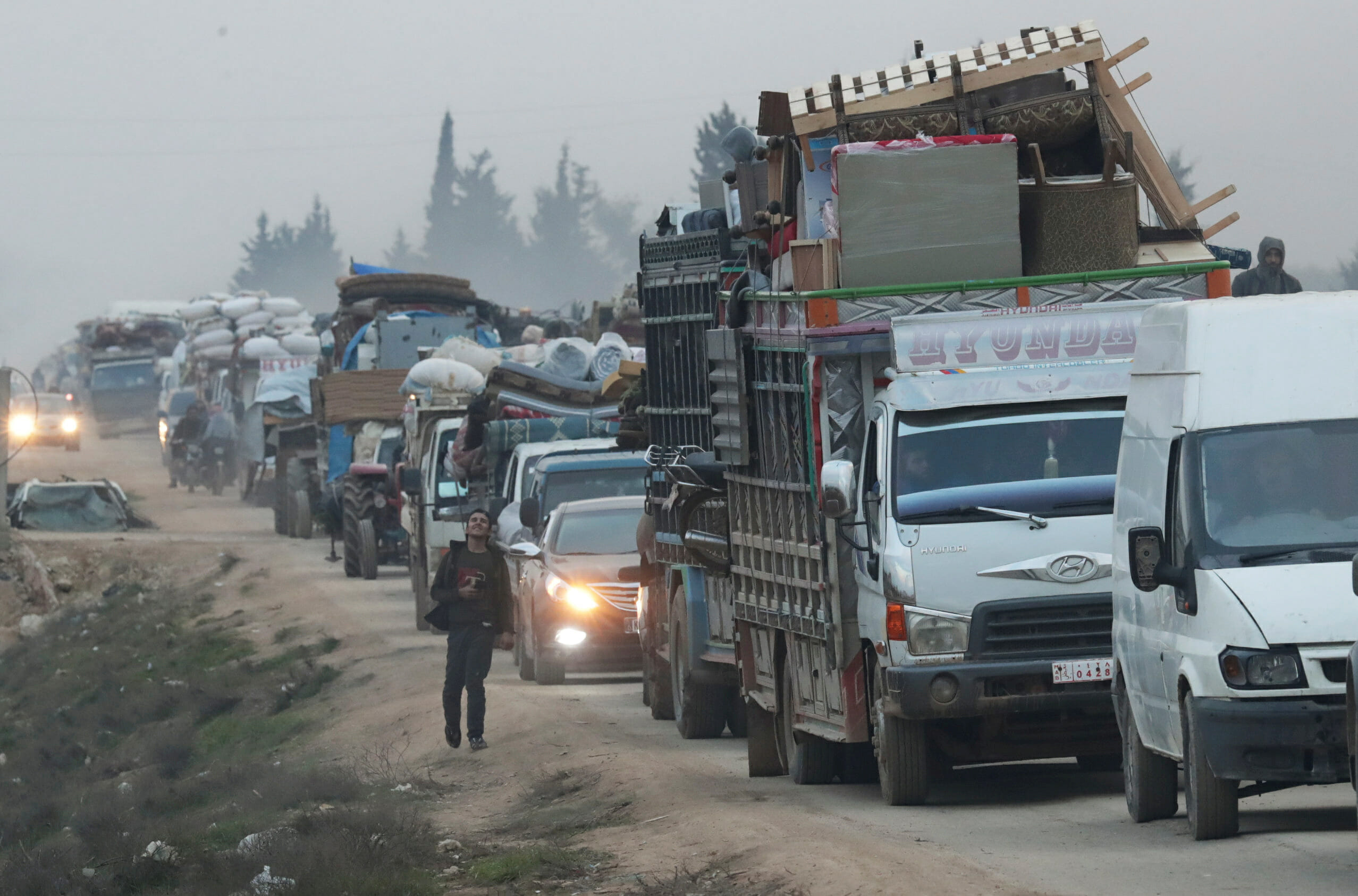 FILE PHOTO: A view of trucks carrying belongings of displaced Syrians, is pictured in the town of Sarmada in Idlib province, Syria, January 28, 2020. REUTERS