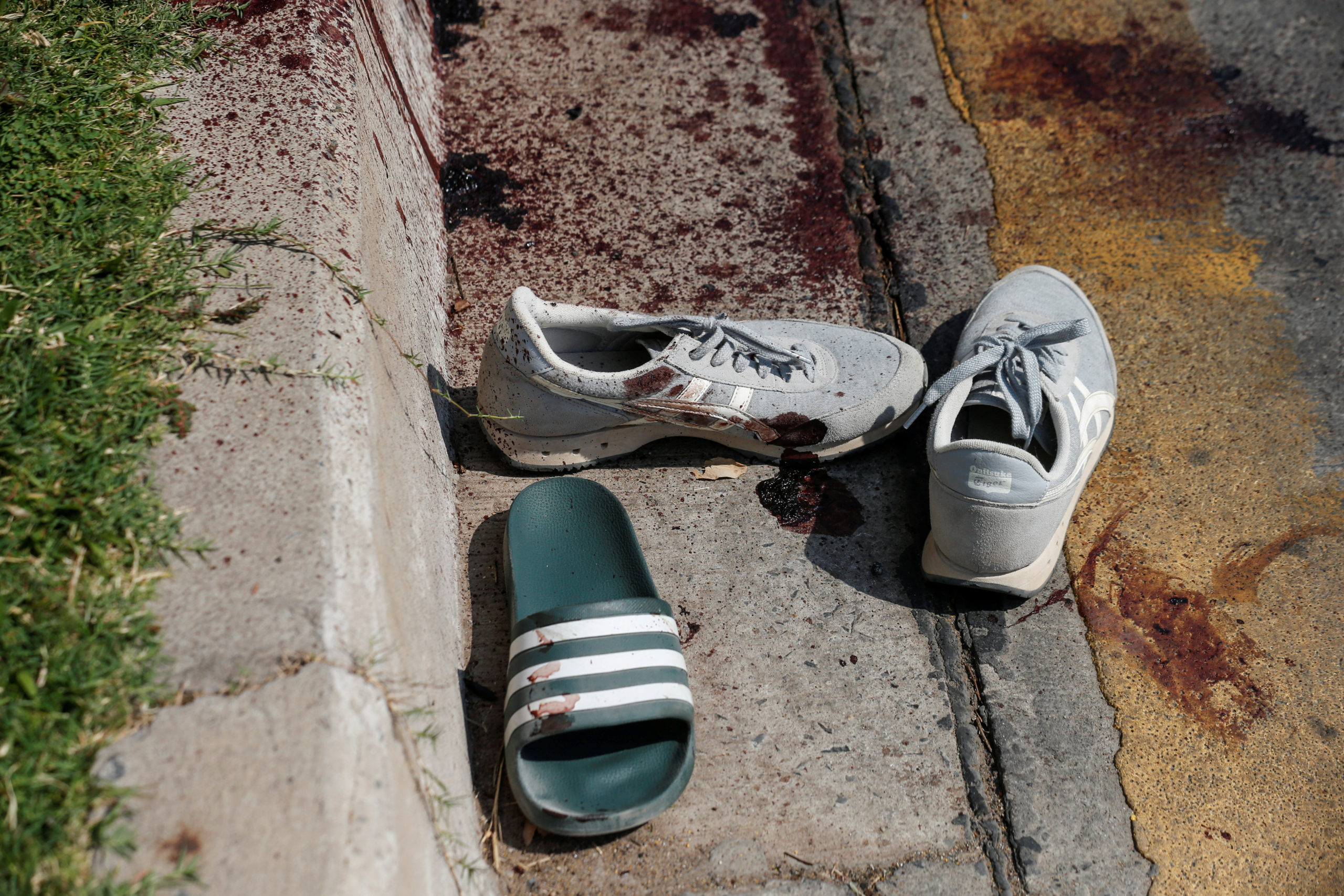 SENSITIVE MATERIAL. THIS IMAGE MAY OFFEND OR DISTURB        Shoes belonging to victims and blood stains are seen in front of the Terminal 21 shopping mall following a gun battle involving a Thai soldier on a shooting rampage, in Nakhon Ratchasima, Thailand February 9, 2020. REUTERS