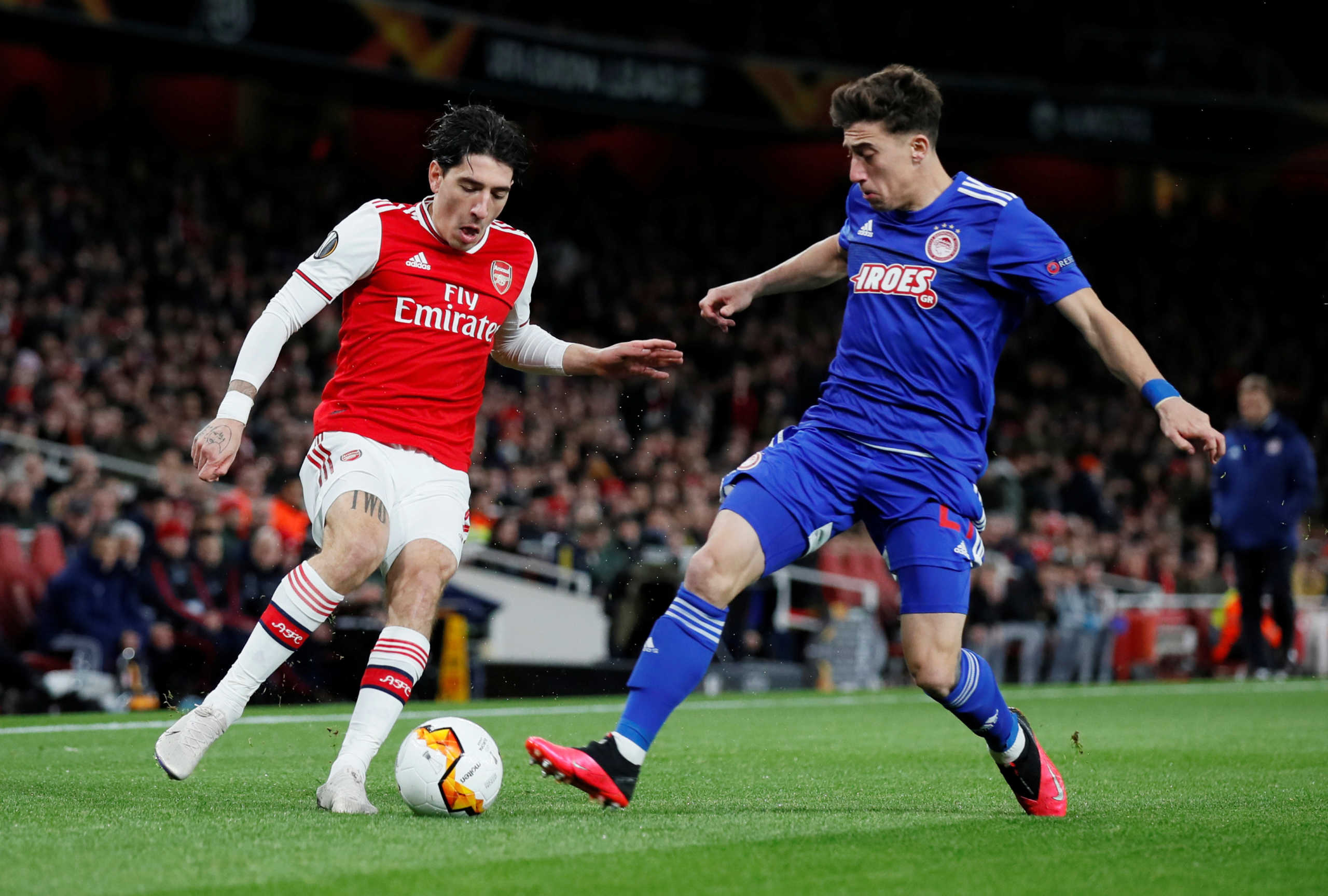 Soccer Football - Europa League - Round of 32 Second Leg - Arsenal v Olympiacos - Emirates Stadium, London, Britain - February 27, 2020  Arsenal's Hector Bellerin in action with Olympiacos' Kostas Tsimikas   REUTERS