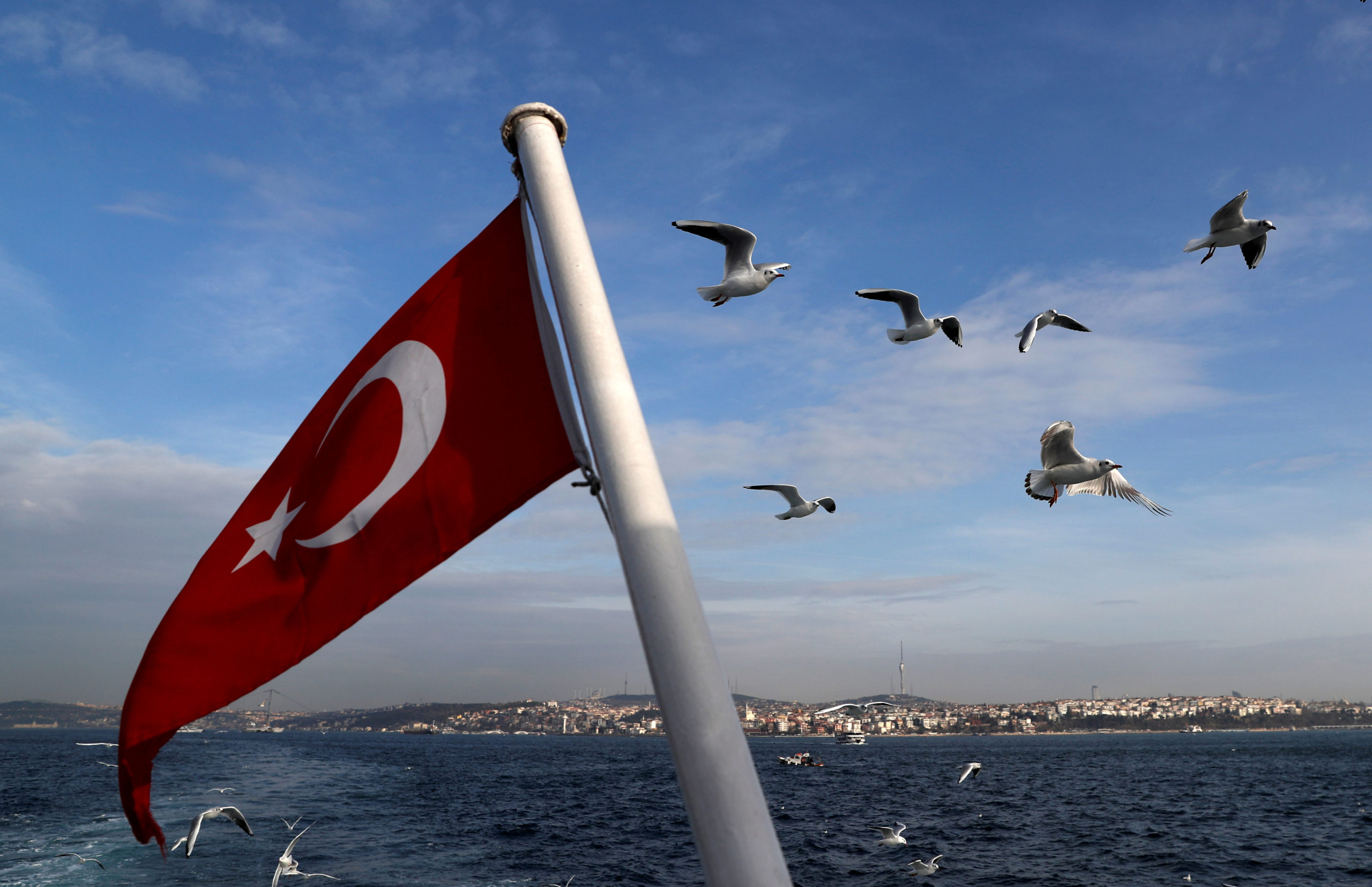 FILE PHOTO: A Turkish flag flies on a passenger ferry with the Bosphorus in the background in Istanbul, Turkey, January 27, 2020. REUTERS