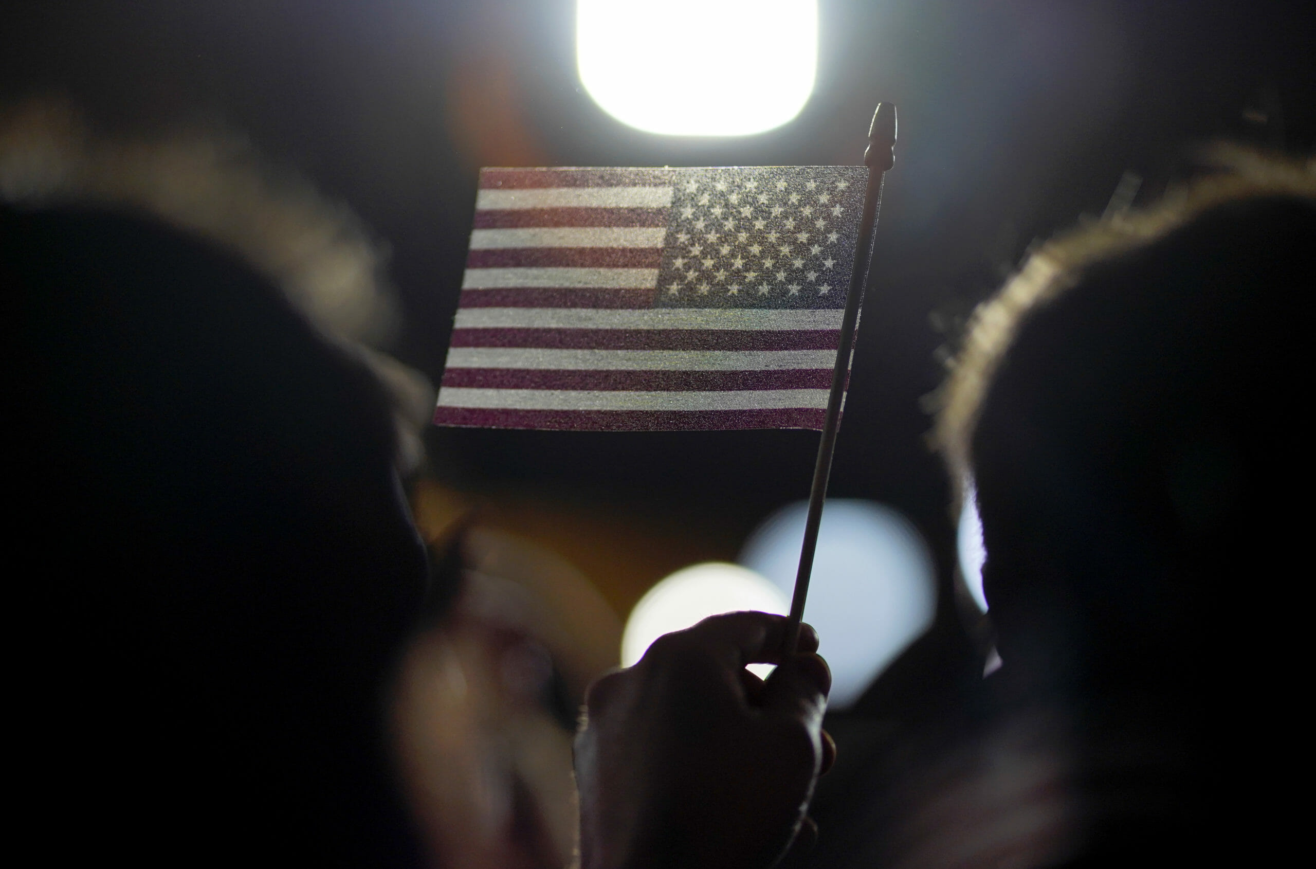 A supporter holds a flag at Democratic U.S. presidential candidate and former South Bend Mayor Pete's New Hampshire primary night rally in Nashua, N.H., U.S., February 11, 2020. REUTERS