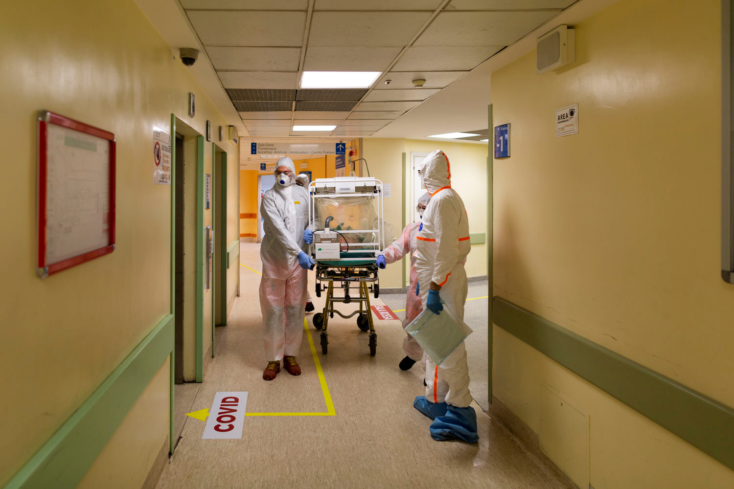 A coronavirus patient arrives on a stretcher at the Columbus Covid Hospital, which has been assigned as one of the new coronavirus treatment hospitals in Rome, after being transferred by medical workers in protective white suits from the Gemelli Hospital, in Rome, Italy, March 16, 2020. Picture taken March 16, 2020. Policlinico Gemelli