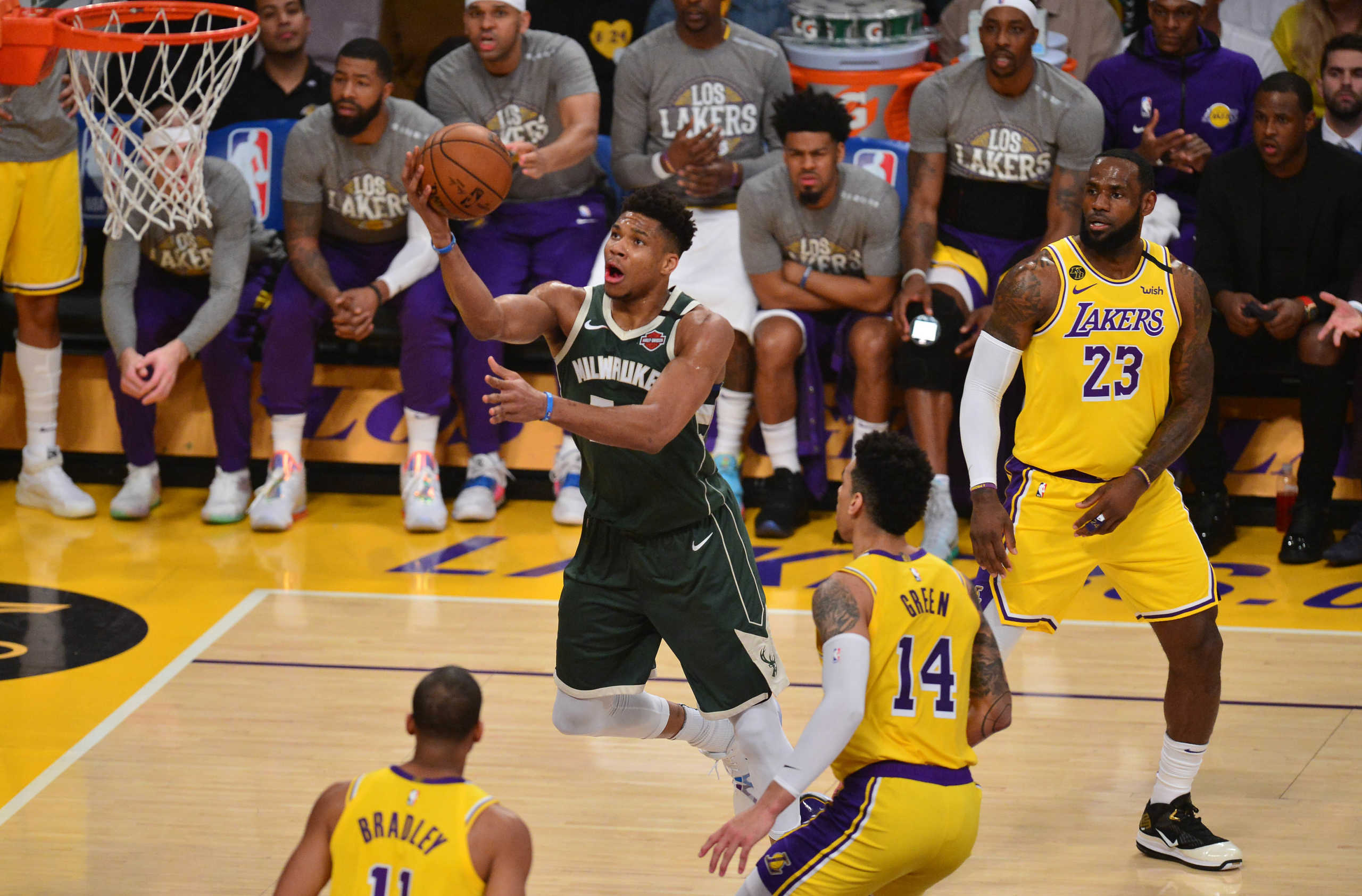 March 6, 2020; Los Angeles, California, USA; Milwaukee Bucks forward Giannis Antetokounmpo (34) moves in to score a basket ahead of Los Angeles Lakers forward LeBron James (23) and guard Danny Green (14) during the first half at Staples Center. Mandatory Credit: Gary A. Vasquez-USA TODAY Sports